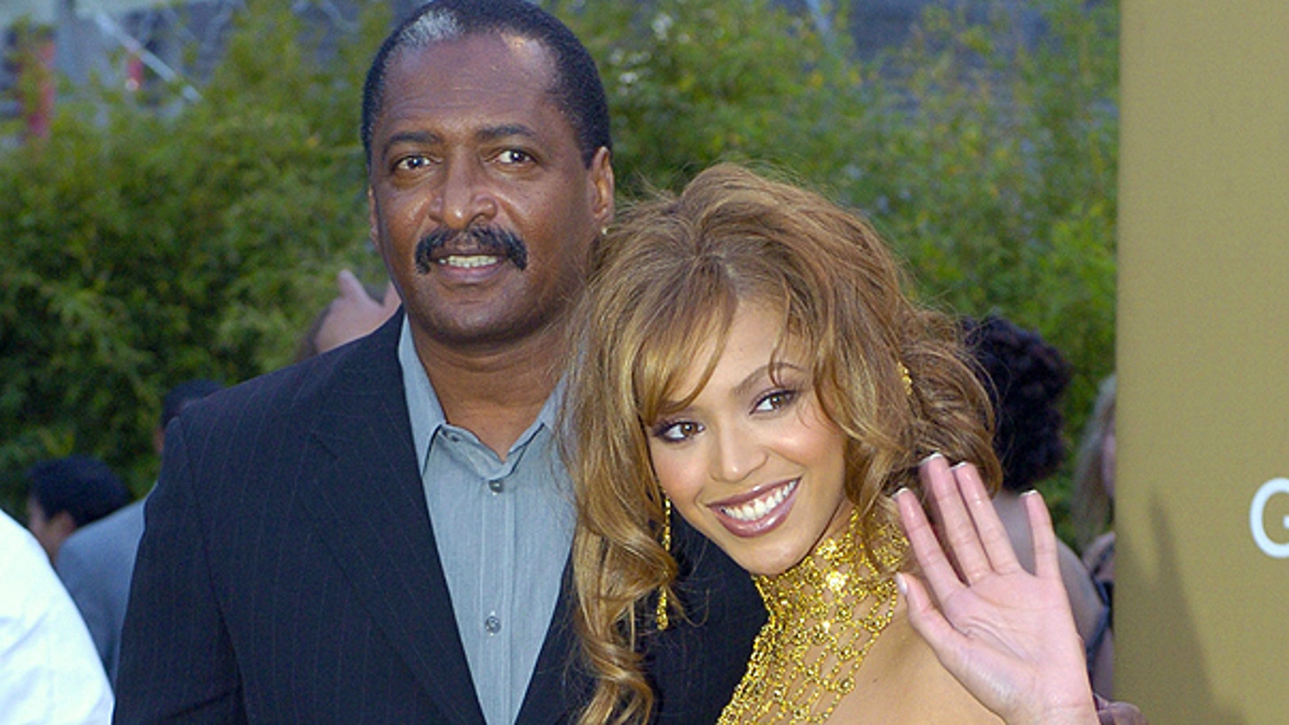 In this Feb. 8, 2004 file photo, singer Beyonce Knowles arrives at the 46th Annual Grammy Awards with her father and manager Mathew Knowles in Los Angeles.