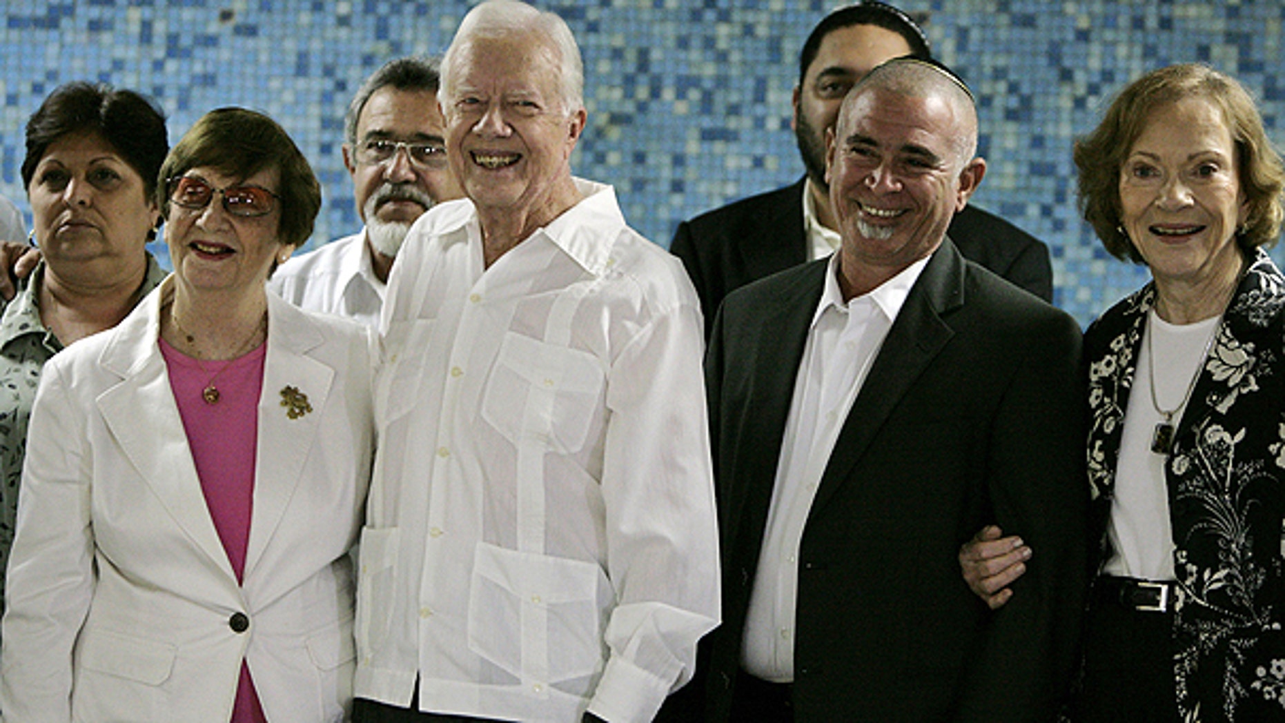 March 28: Authorities, front row, from left, Adela Dworin, President of the Cuban Jewish Community, former President Jimmy Carter, David Prinstein, Vice-President of the Cuban Jewish Community and Carter's wife Rosalynn Carter, pose for pictures during a visit to members of the Cuba Jewish Community in Havana, Cuba.