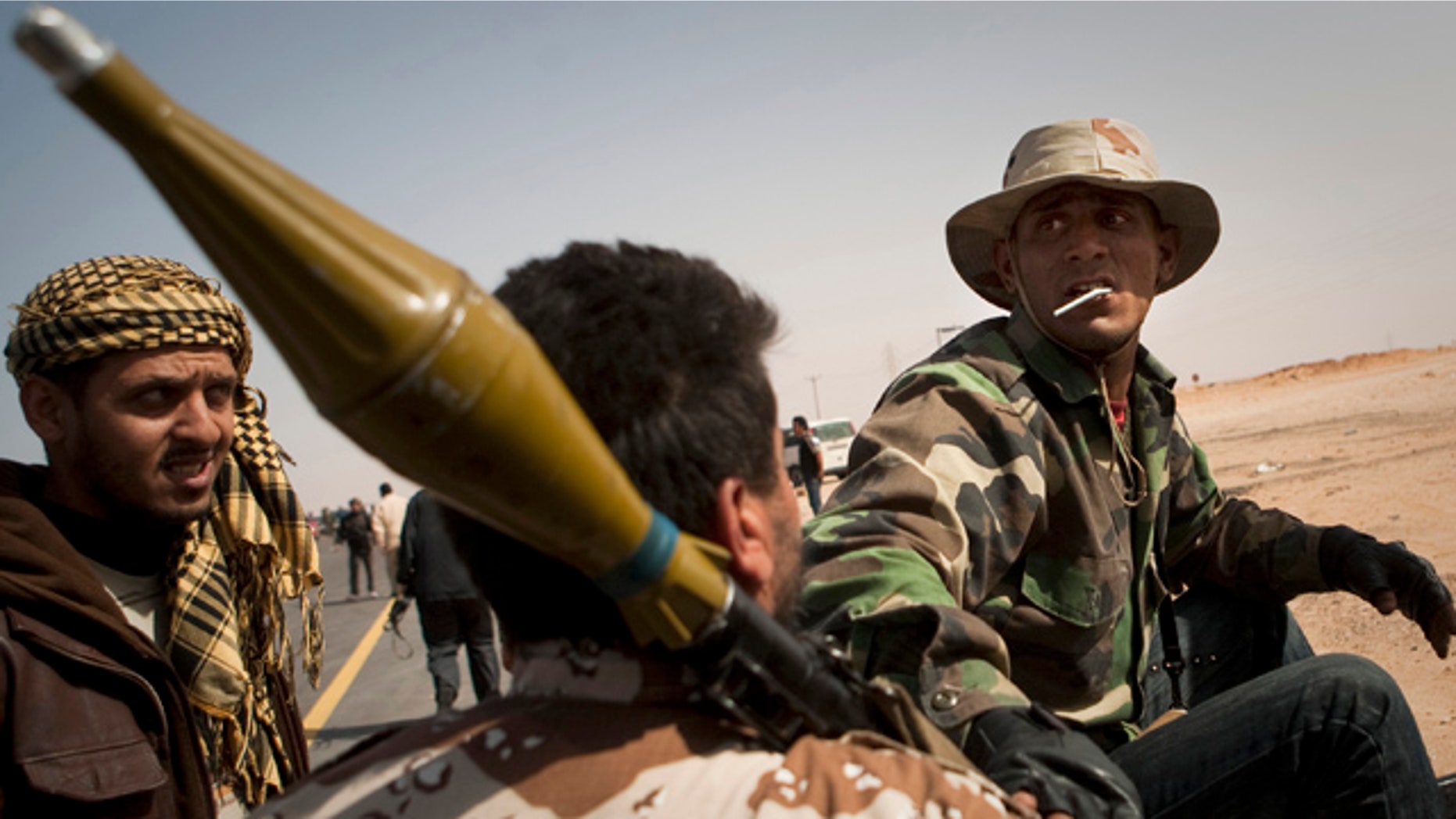 March 29: A Libyan rebel prepares their ammunition on the frontline outside of Bin Jawaad, 150km east of Sirte, central Libya.