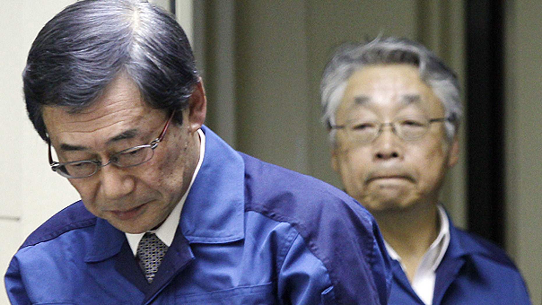 March 13: Masataka Shimizu, president of Tokyo Electric Power Co., left, and Executive Vice President Takashi Fujimoto, right, enter the venue of the press conference in Tokyo, Japan.