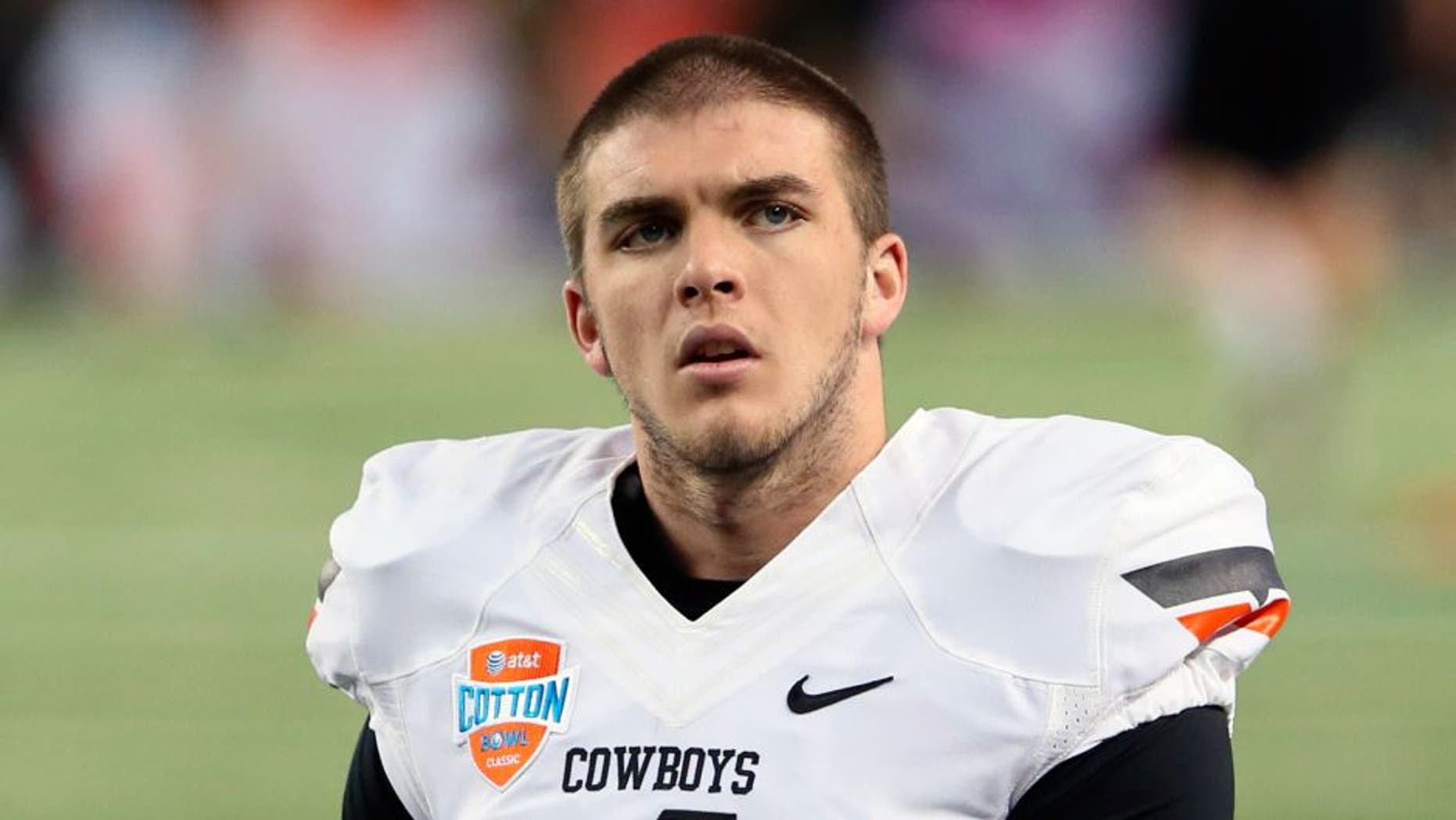 Jan 3, 2014; Arlington, TX, USA; Oklahoma State Cowboys quarterback J.W. Walsh (4) before the game against the Missouri Tigers in the 2014 Cotton Bowl at AT&T Stadium. Missouri won 41-31. Mandatory Credit: Kevin Jairaj-USA TODAY Sports