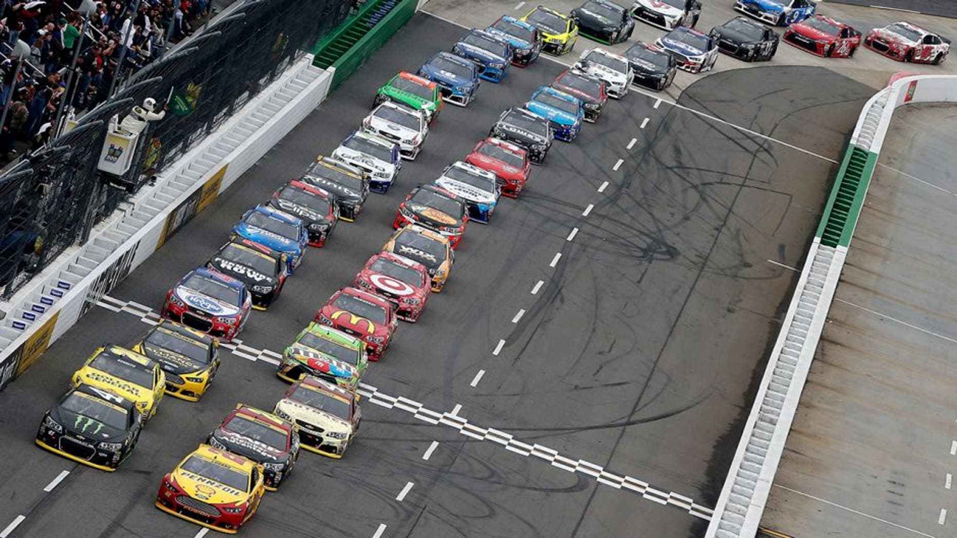 MARTINSVILLE, VA - NOVEMBER 01: Joey Logano, driver of the #22 Shell Pennzoil Ford, and Kurt Busch, driver of the #41 Monster Energy Chevrolet, lead the field to a restart during the NASCAR Sprint Cup Series Goody's Headache Relief Shot 500 at Martinsville Speedway on November 1, 2015 in Martinsville, Virginia. (Photo by Brian Lawdermilk/NASCAR via Getty Images)