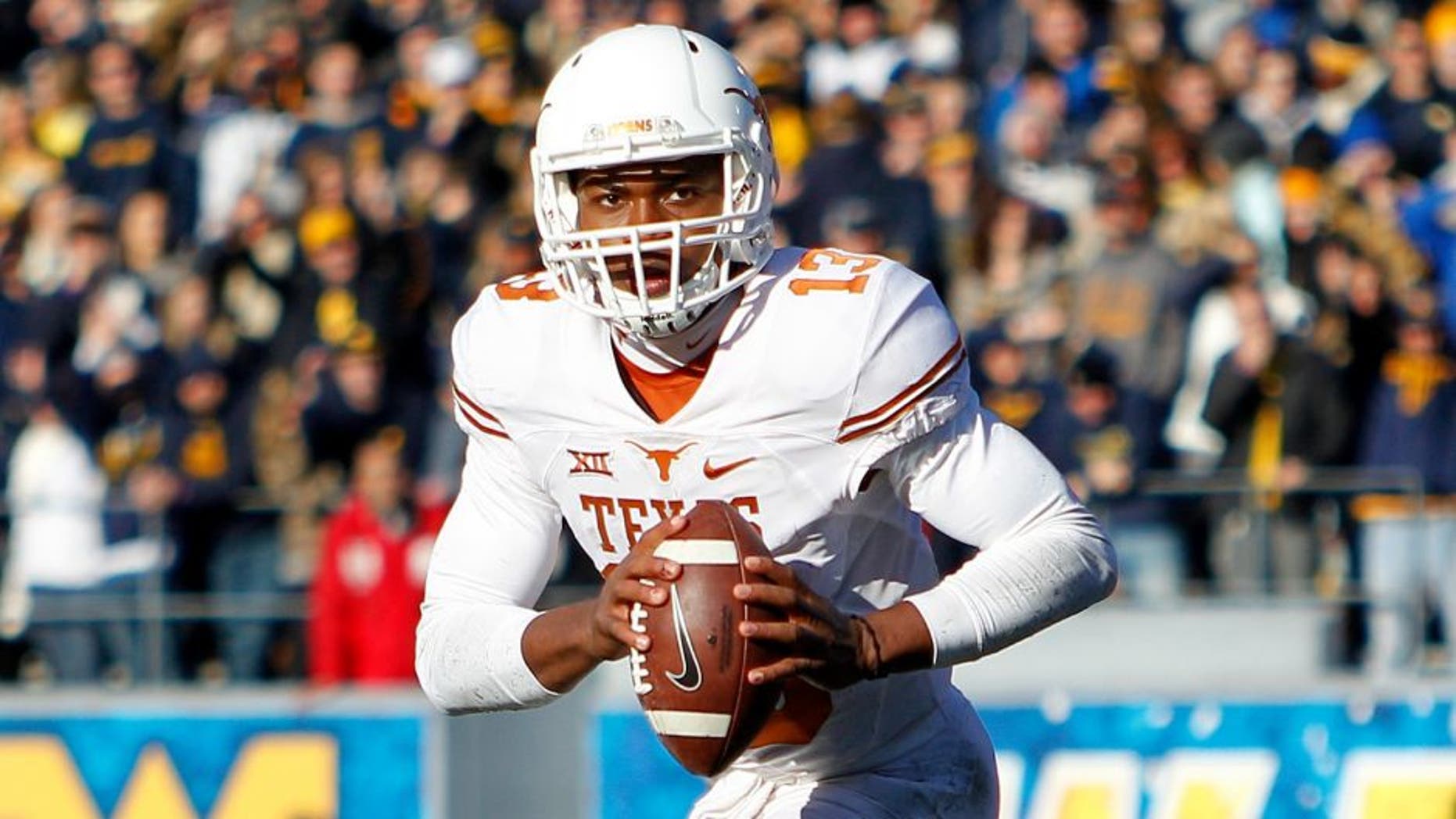 MORGANTOWN, WV - NOVEMBER 14: Jerrod Heard #13 of the Texas Longhorns in action during the game against the West Virginia Mountaineers on November 14, 2015 at Mountaineer Field in Morgantown, West Virginia. (Photo by Justin K. Aller/Getty Images)