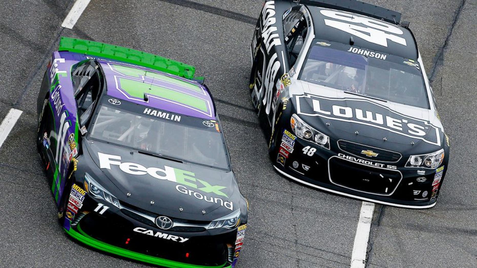 MARTINSVILLE, VA - NOVEMBER 01: Denny Hamlin, driver of the #11 FedEx Ground Toyota, races Jimmie Johnson, driver of the #48 KOBALT TOOLS Chevrolet, during the NASCAR Sprint Cup Series Goody's Headache Relief Shot 500 at Martinsville Speedway on November 1, 2015 in Martinsville, Virginia. (Photo by Jeff Zelevansky/Getty Images)