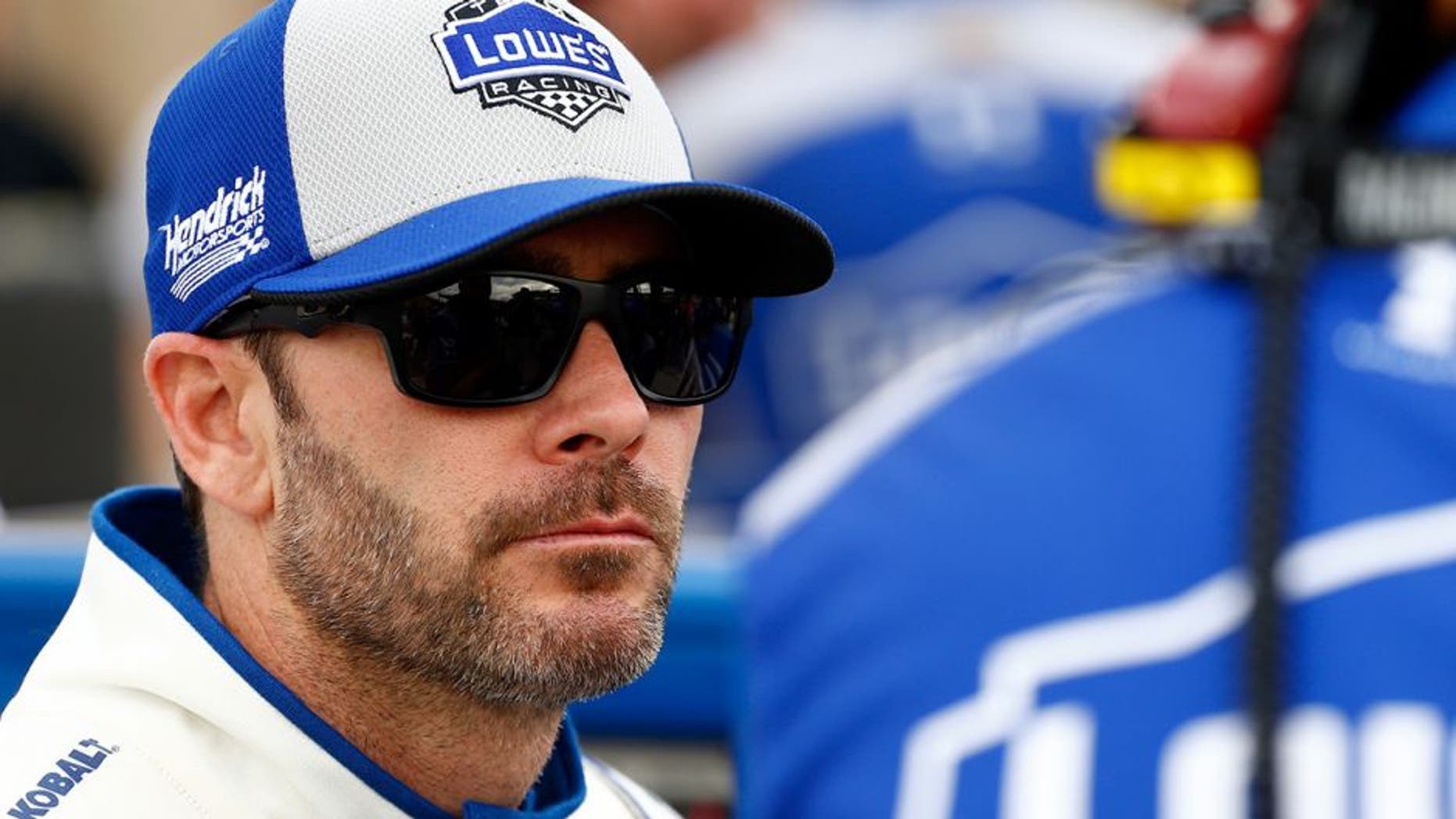 AVONDALE, AZ - MARCH 11: Jimmie Johnson, driver of the #48 Lowe's Pro Services Chevrolet, talks to a crew member on the grid during qualifying for the NASCAR Sprint Cup Series Good Sam 500 at Phoenix International Raceway on March 11, 2016 in Avondale, Arizona. (Photo by Daniel Shirey/Getty Images)