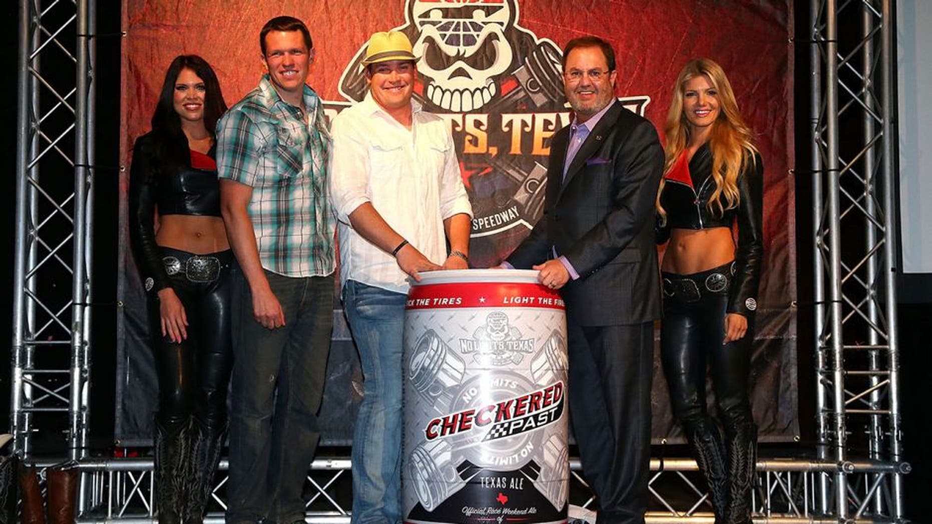 DALLAS, TEXAS - MARCH 30: Texas Motor Speedway President Eddie Gossage and Scott Lindsey, owner of Audacity Brew House in Denton, Texas unveil the new Checkered Past beer during the Texas Motor Speedway Media Day at Gilley's Dallas on March 30, 2016 in Dallas, Texas. (Photo by Sarah Crabill/Getty Images for Texas Motor Speedway)