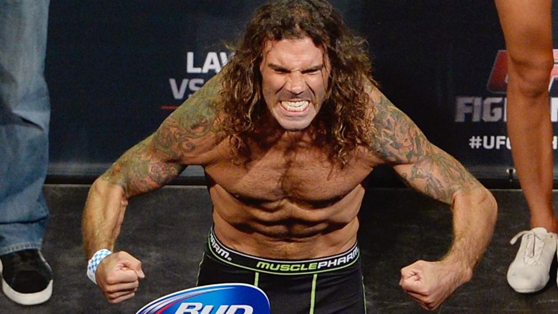 Clay 'The Carpenter' Guida steps on the scale during the UFC Fight Night weigh-in event at the SAP Center on July 25, 2014 in San Jose, California. (Photo by Jeff Bottari/Zuffa LLC/Zuffa LLC via Getty Images)