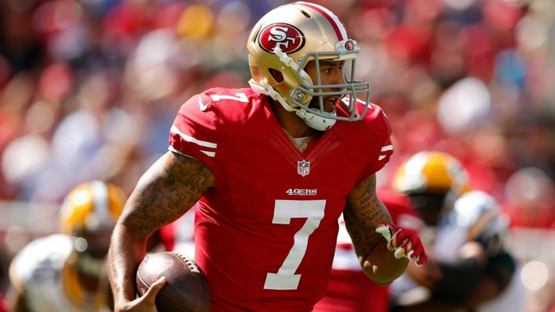 during their NFL game at Levi's Stadium on October 4, 2015 in Santa Clara, California.,SANTA CLARA, CA - OCTOBER 04: Quarterback Colin Kaepernick #7 of the San Francisco 49ers runs with the ball against the Green Bay Packers during their NFL game at Levi's Stadium on October 4, 2015 in Santa Clara, California. (Photo by Ezra Shaw/Getty Images)