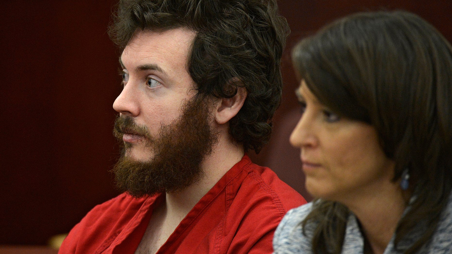 FILE - In this March 12, 2013 file photo, James Holmes, left, and defense attorney Tamara Brady appear in district court in Centennial, Colo. for his arraignment. Lawyers for Holmes, the man accused of killing 12 people and injuring 70 in a Colorado movie theater, said Tuesday May 7, 2013 he wants to change his plea to not guilty by reason of insanity. (AP Photo/The Denver Post, RJ Sangosti, Pool, File)