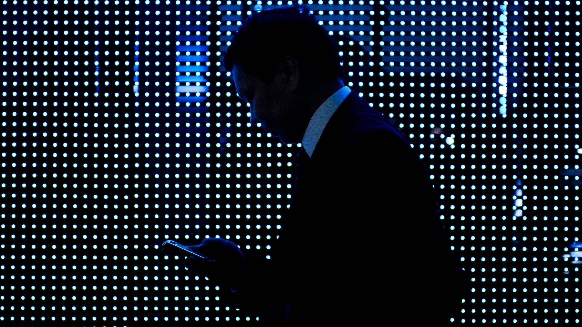 BARCELONA, SPAIN - FEBRUARY 14: A visitor checks his mobile phone as he attends the 1st day of Mobile World Congress on February 14, 2011 in Barcelona, Spain. The Mobile World Congress hosts some of the world's largest communication companies and runs from February 14 -17. (Photo by David Ramos/Getty Images)