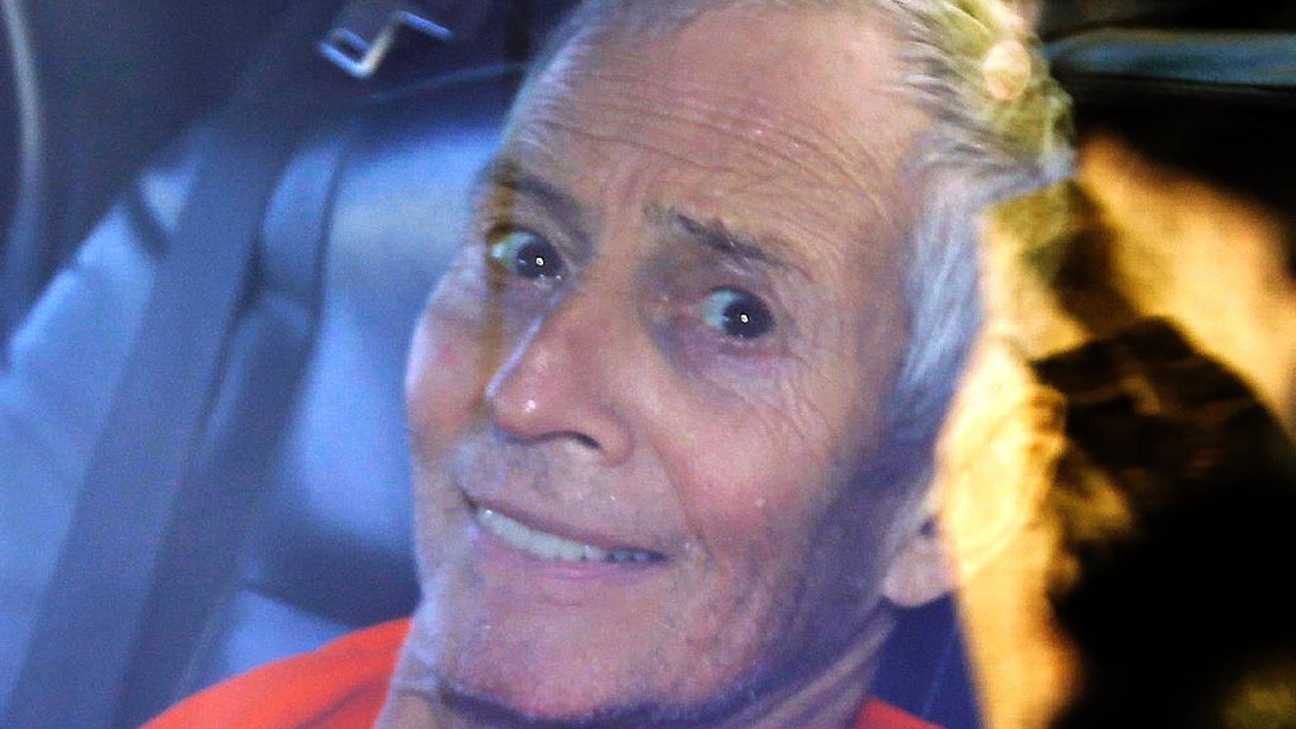 FILE - In this Tuesday, March 17, 2015, file photo, millionaire Robert Durst is escorted from Orleans Parish Criminal District Court to the Orleans Parish Prison after his arraignment in New Orleans. Durst returns to court Thursday, April 2, 2015, where his attorneys plan to argue that the FBI searched his room illegally and police covered this up in statements used to get an arrest warrant on Louisiana weapons charges. (AP Photo/Gerald Herbert, File)