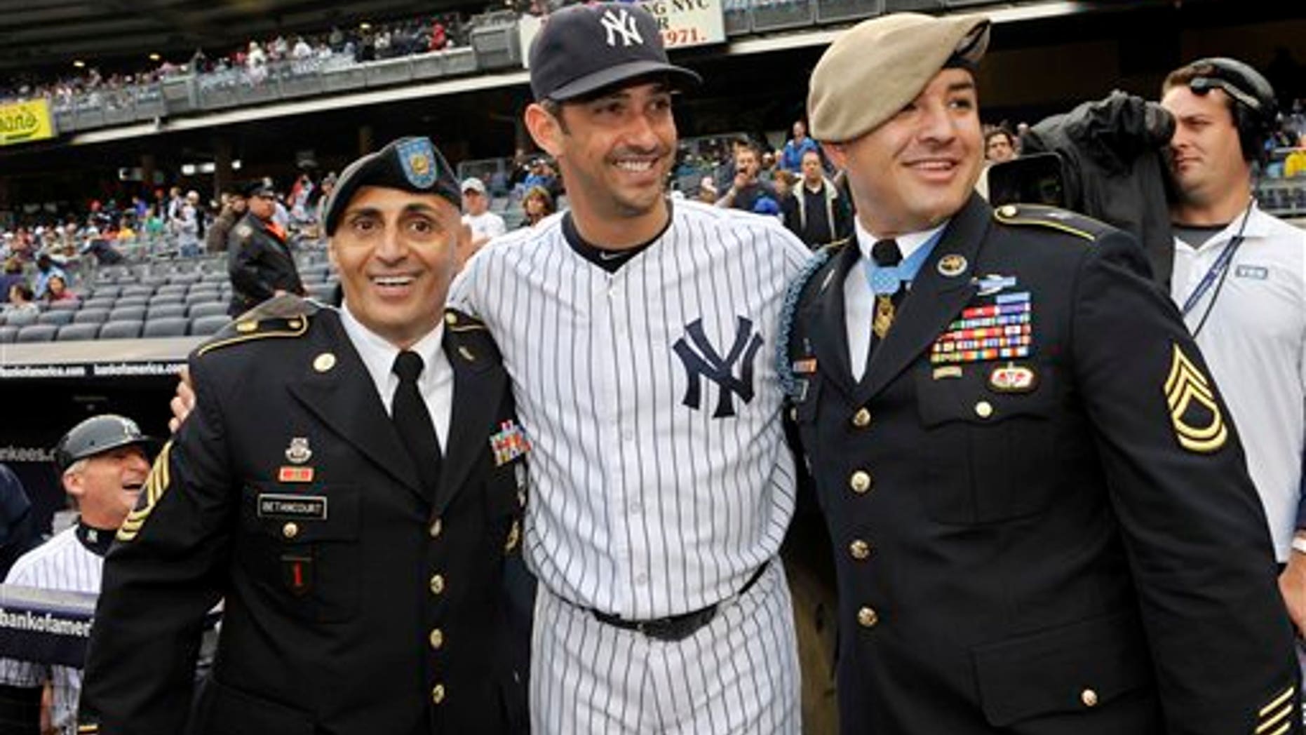Sept 7: New York Yankees' Jorge Posada greets U.S. Army Sgt. Al Betancourt, left, and Congressional Medal of Honor awardee Sgt. 1st Class Leroy Petry before ceremonies to honor the 10-year anniversary of September 11, 2001