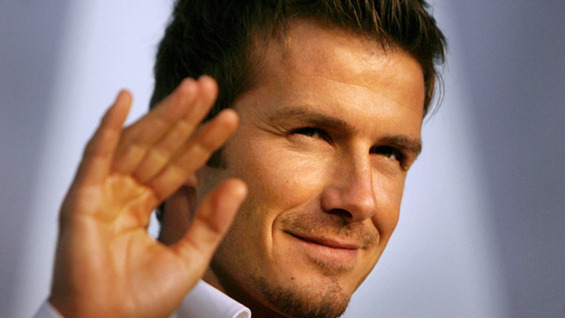 FILE - In this Dec. 29, 2006 file photo, Real Madrid soccer star David Beckham waves to fans during a promotional event in Tokyo. Beckham says he is retiring from soccer at the end of the season. The 38-year-old Beckham recently won a league title in a fourth country with Paris Saint-Germain. He has become a global superstar since starting his career at Manchester United. (AP Photo/David Guttenfelder, File)
