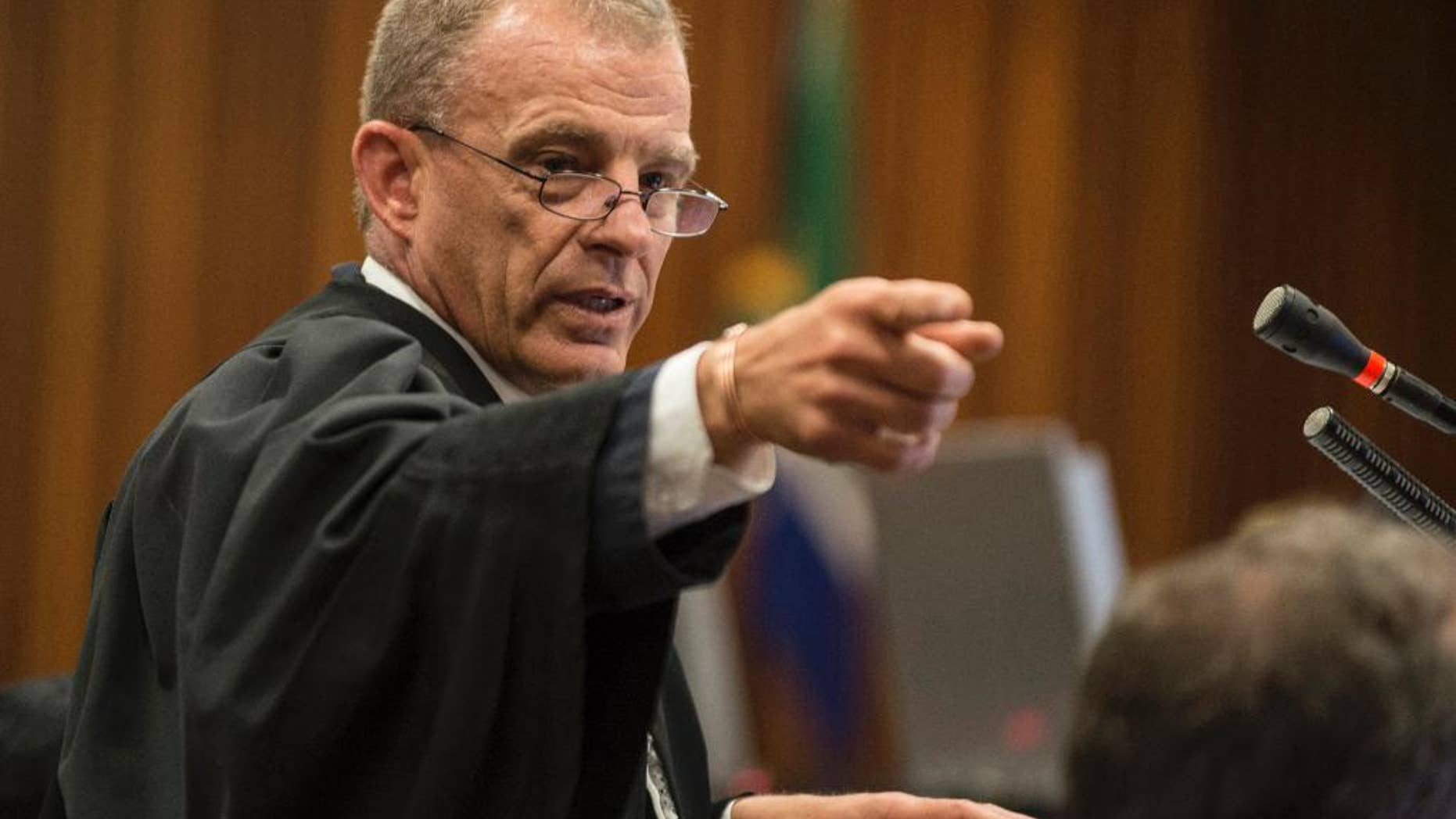 FILE -- In this Thursday, Aug. 7, 2014 file photo, state prosecutor Gerrie Nel gestures, during the Oscar Pistorius murder trial in Pretoria, South Africa. Nel announced Tuesday, Jan. 31, 2017 that he has quit his position and will head AfriForum's new private prosecuting unit, which will target state officials and politicians suspected of graft. (AP Photo/Mujahid Safodien, Pool, File)