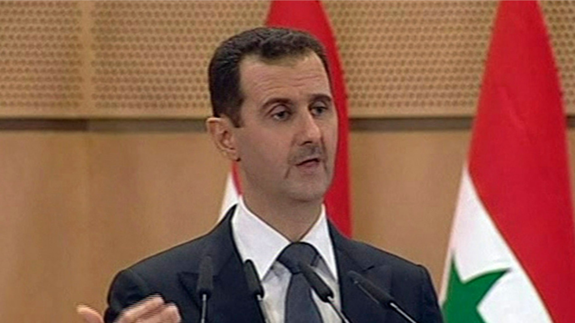 June 20: In this screen grab taken from Syrian TV, Syria's President, Bashar Assad delivers a speech in Damascus.