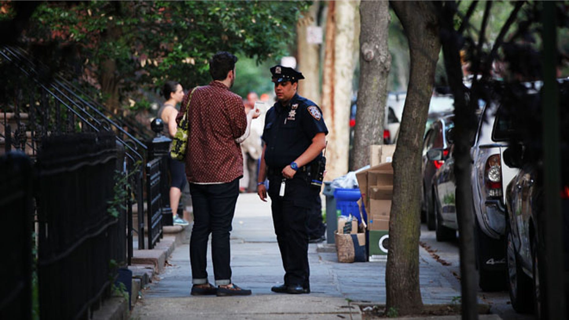 NEW YORK, NY - JUNE 10: Police officers are seen by a crime scene where three people were shot on June 10, 2015 in the Gowanus area of the Brooklyn Borough of New York City. In an effort to combat the rise in murders and shootings, hundreds of additional New York City Police Officers will begin walking city streets as part of an aggressive NYPD initiative called "Summer All Out." About 330 officers will be taken off of administrative duty to patrol the streets in some of the city's most violent neighborhoods. (Photo by Spencer Platt/Getty Images)