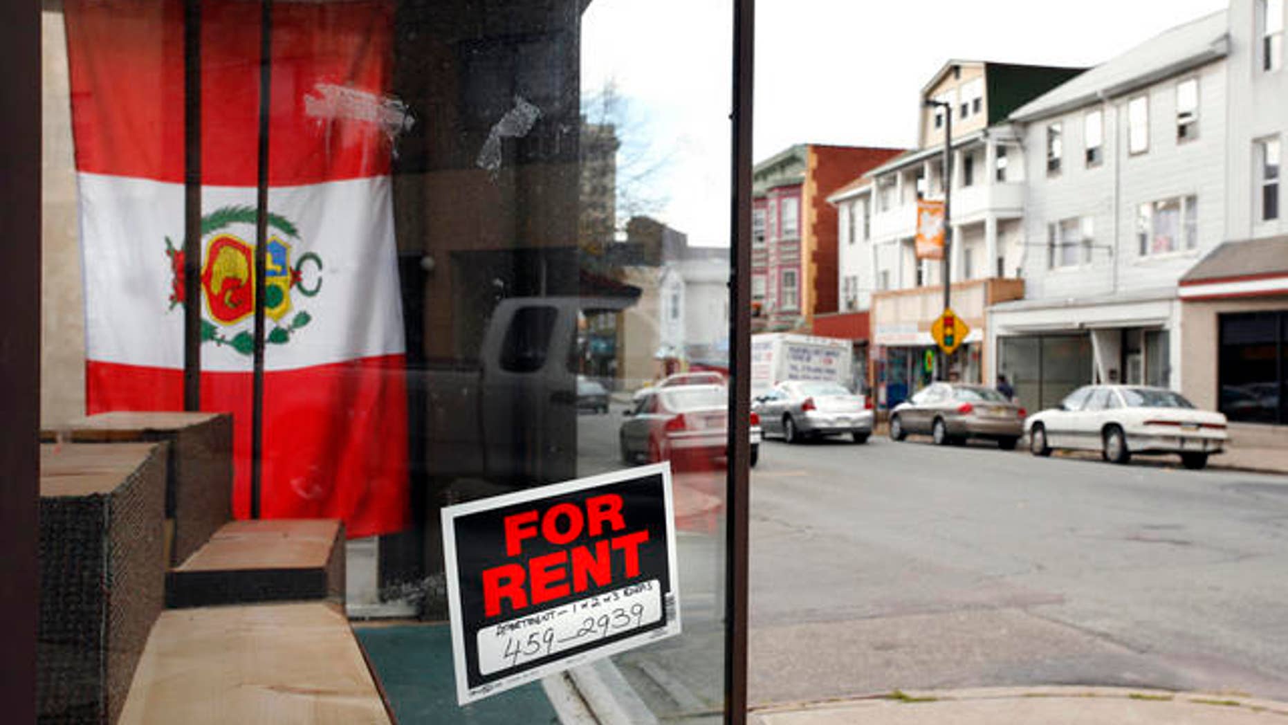 A storefront with a Peruvian flag in the window is shown for rent Thursday, Oct. 26, 2006 in Hazleton, Pa. This small hillside city in northeastern Pennsylvania has yet to enforce a tough, first-of-its-kind law targeting illegal immigrants, but evidence suggests that many Hispanics, illegal immigrants or otherwise, have already left. That has hobbled the city's Hispanic business district, where shops that flourished only six months ago have either closed or are struggling to stay open.(AP Photo/Steve Klaver)