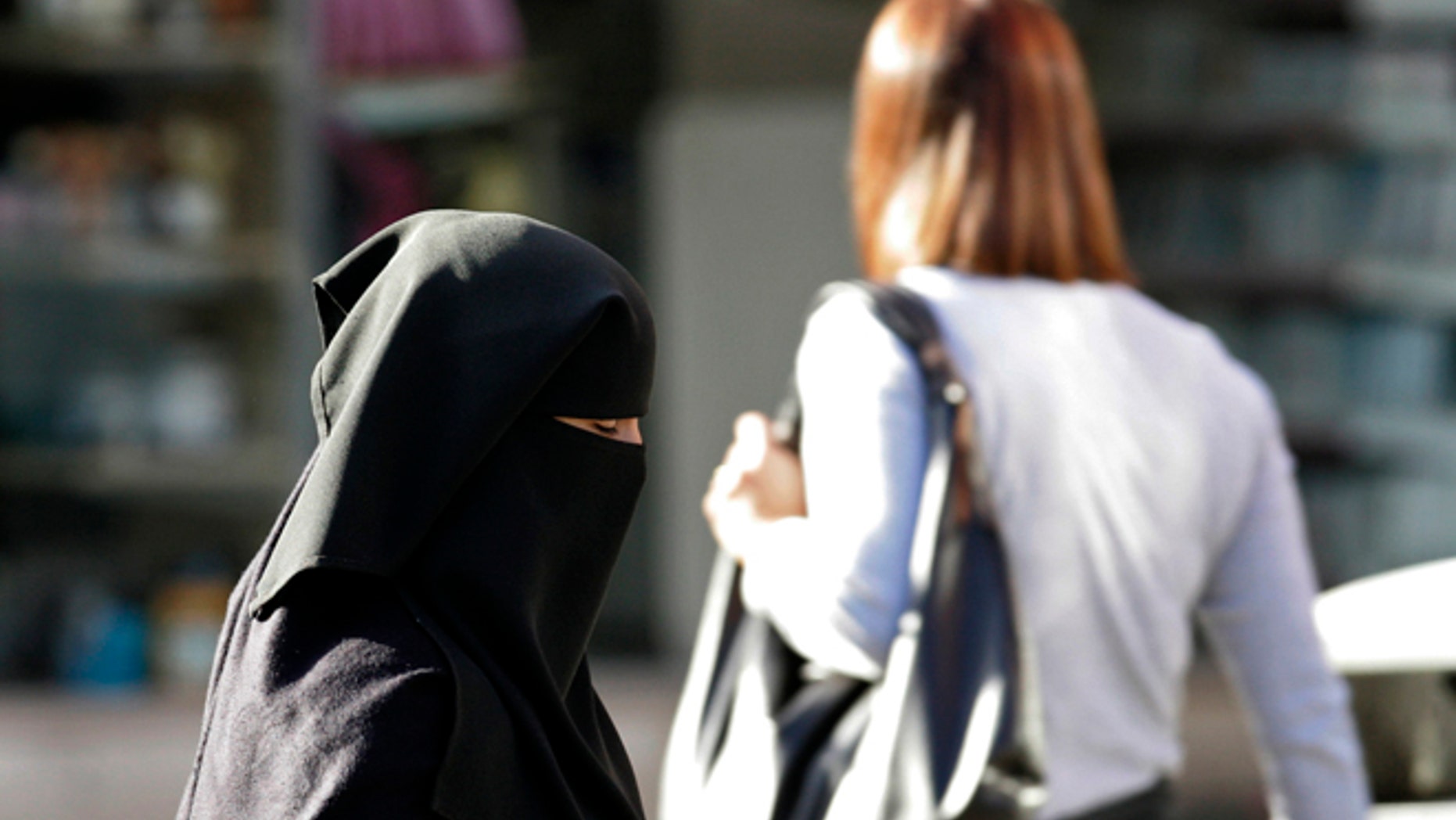 A Muslim woman walks down the street in Blackburn, England.