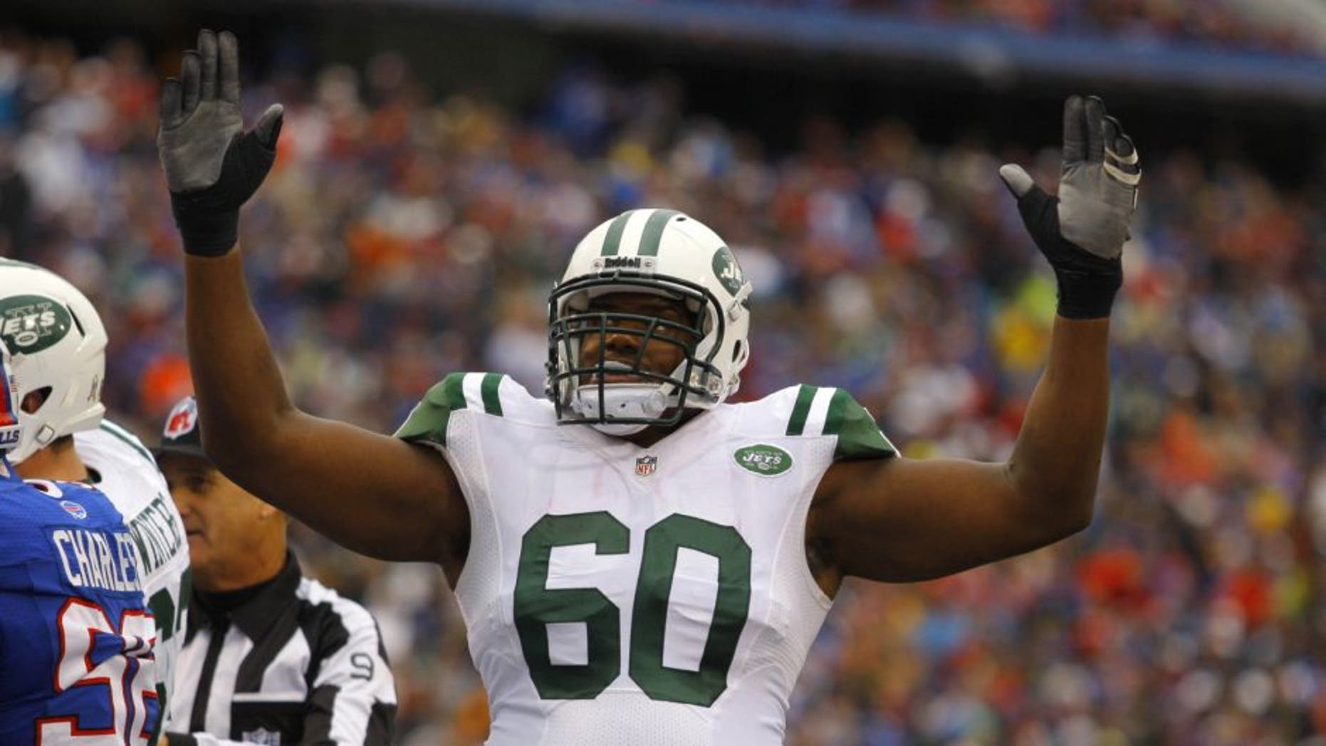 Nov 17, 2013; Orchard Park, NY, USA; New York Jets tackle D'Brickashaw Ferguson (60) celebrates a touchdown during the second half against the Buffalo Bills at Ralph Wilson Stadium. Bills beat the Jets 37-14. Mandatory Credit: Timothy T. Ludwig-USA TODAY Sports