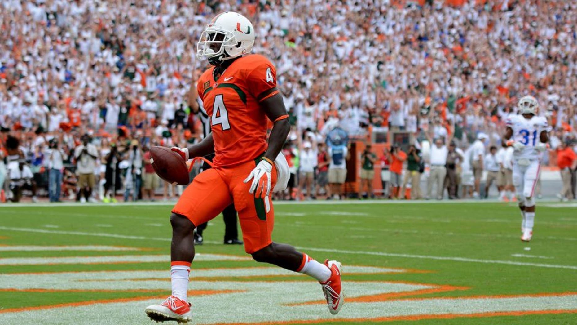 Sep 7, 2013; Miami Gardens, FL, USA; Miami Hurricanes wide receiver Phillip Dorsett (4) scores untouched against the Florida Gators during the first half of the game at Sun Life Stadium. Mandatory Credit: Brad Barr-USA TODAY Sports