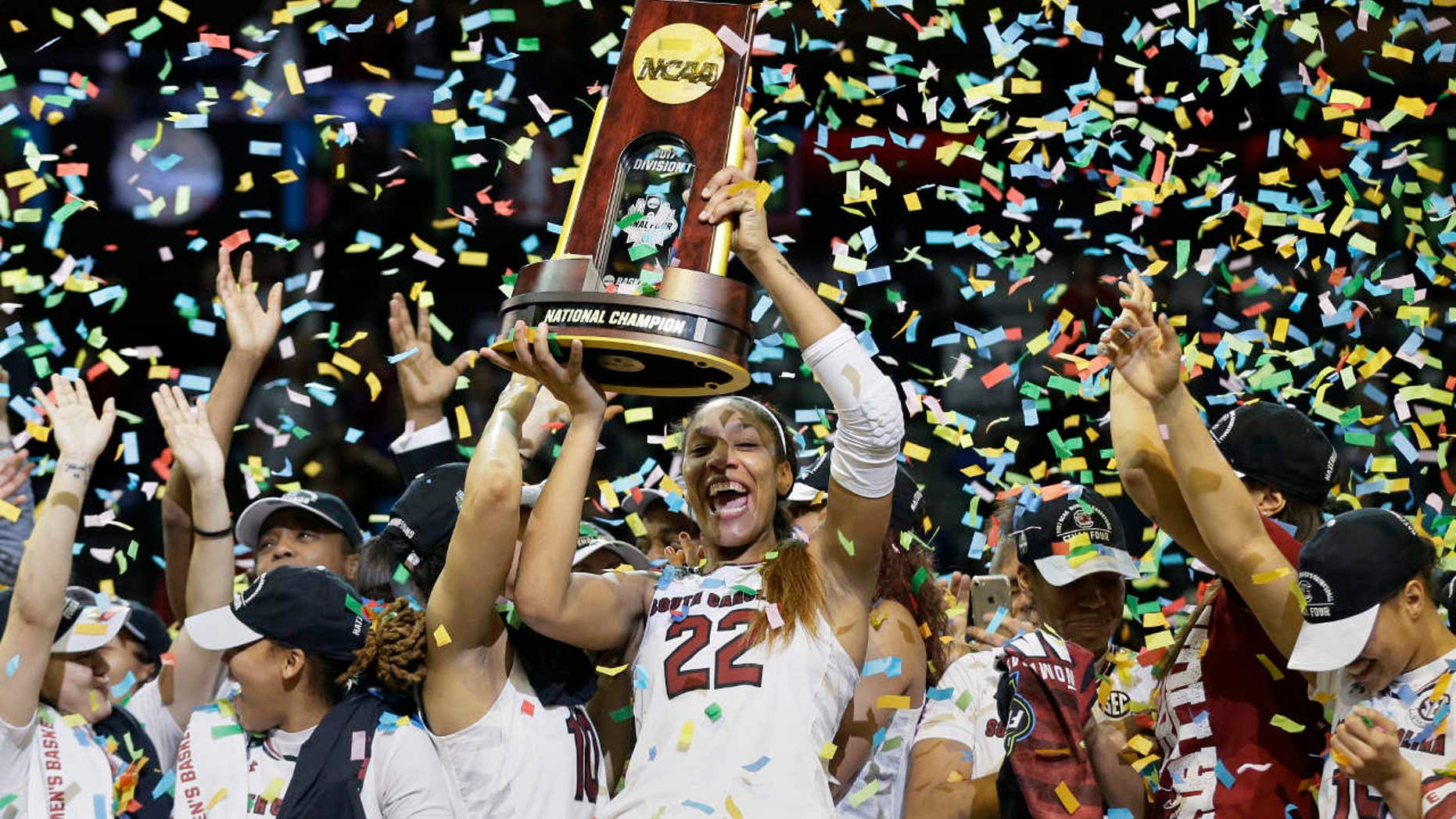 South Carolina forward A'ja Wilson (22) holds the trophy as she and her teammates celebrate a win over Mississippi State in the final of NCAA women's Final Four college basketball tournament, Sunday, April 2, 2017, in Dallas.