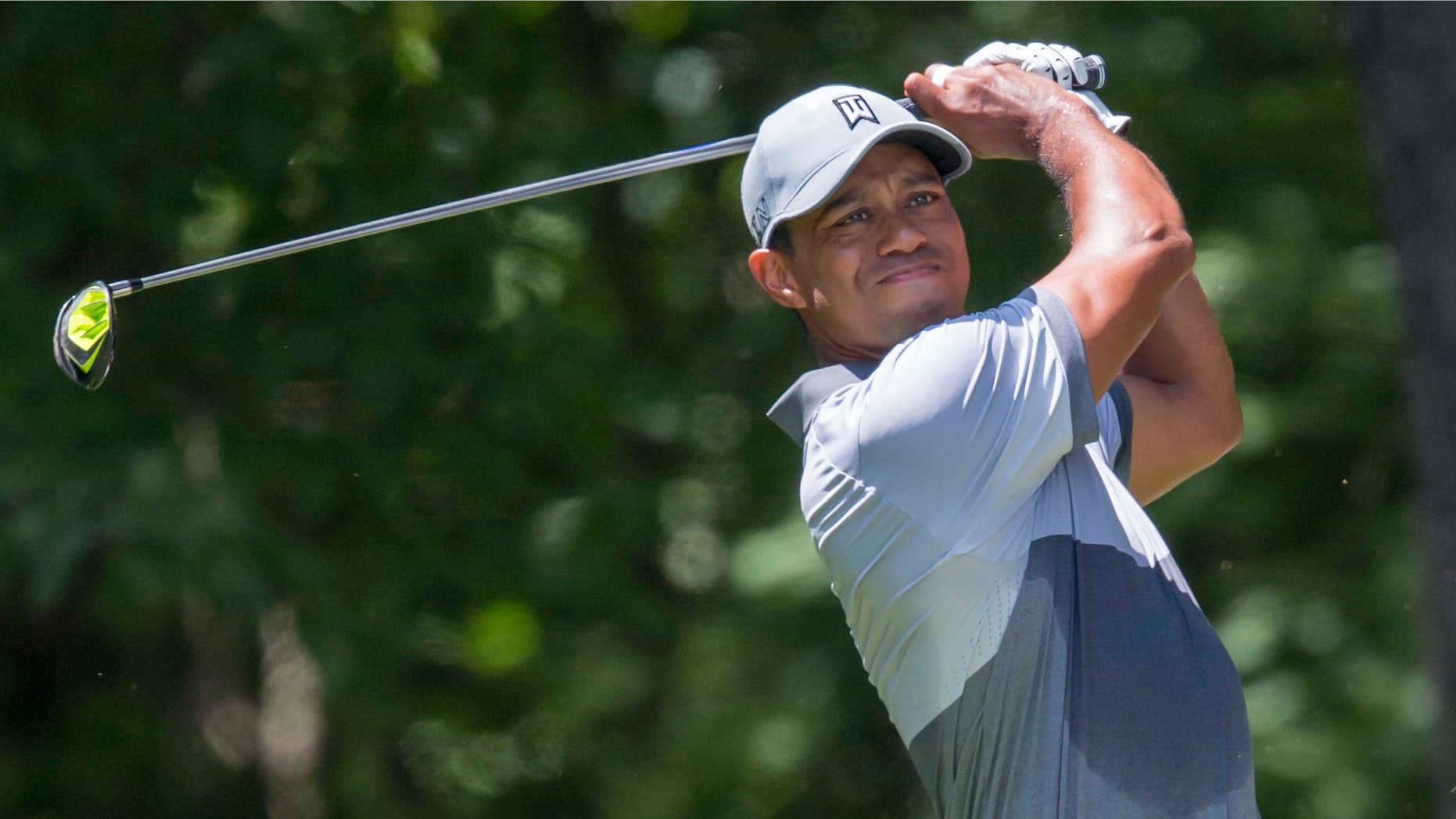 FILE - In this Saturday, Aug. 22, 2015 file photo, Tiger Woods tees off on the second hole during the third round of the Wyndham Championship golf tournament at Sedgefield Country Club in Greensboro, N.C.