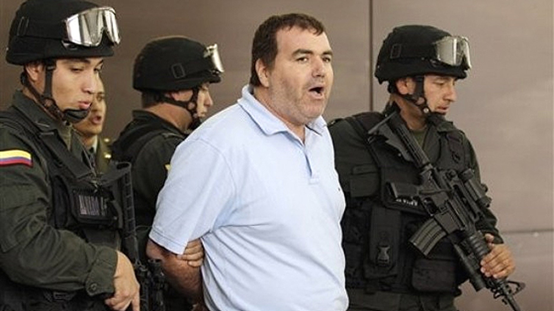 Aug. 20, 2010: Police escort suspected drug trafficker Walid Makled Garcia, from Venezuela, center, during a press conference at police headquarters in Bogota, Colombia.