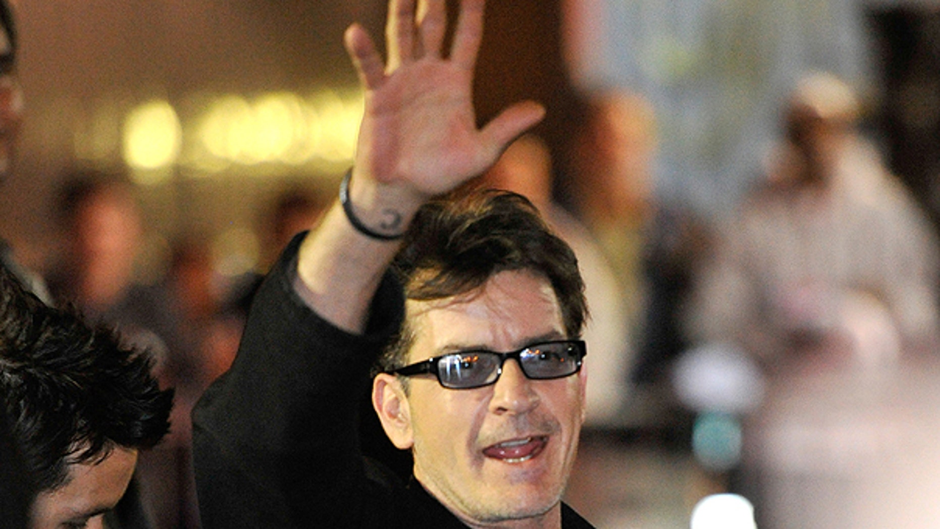 April 3: Charlie Sheen waves to fans as he leaves the Chicago Theatre in Chicago.