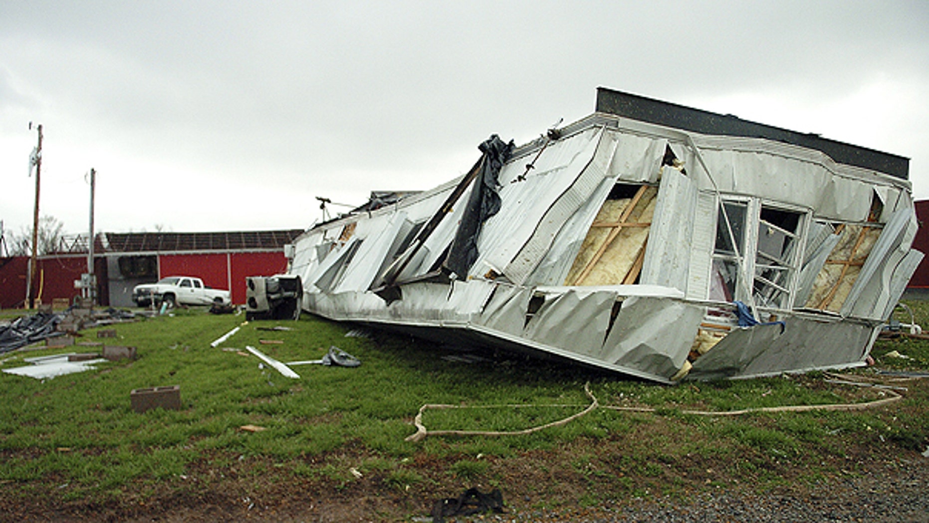 April 4: The mobile home of Eric Williams came to rest on its roof after severe storms ripped through the area near LaCenter, Ky.