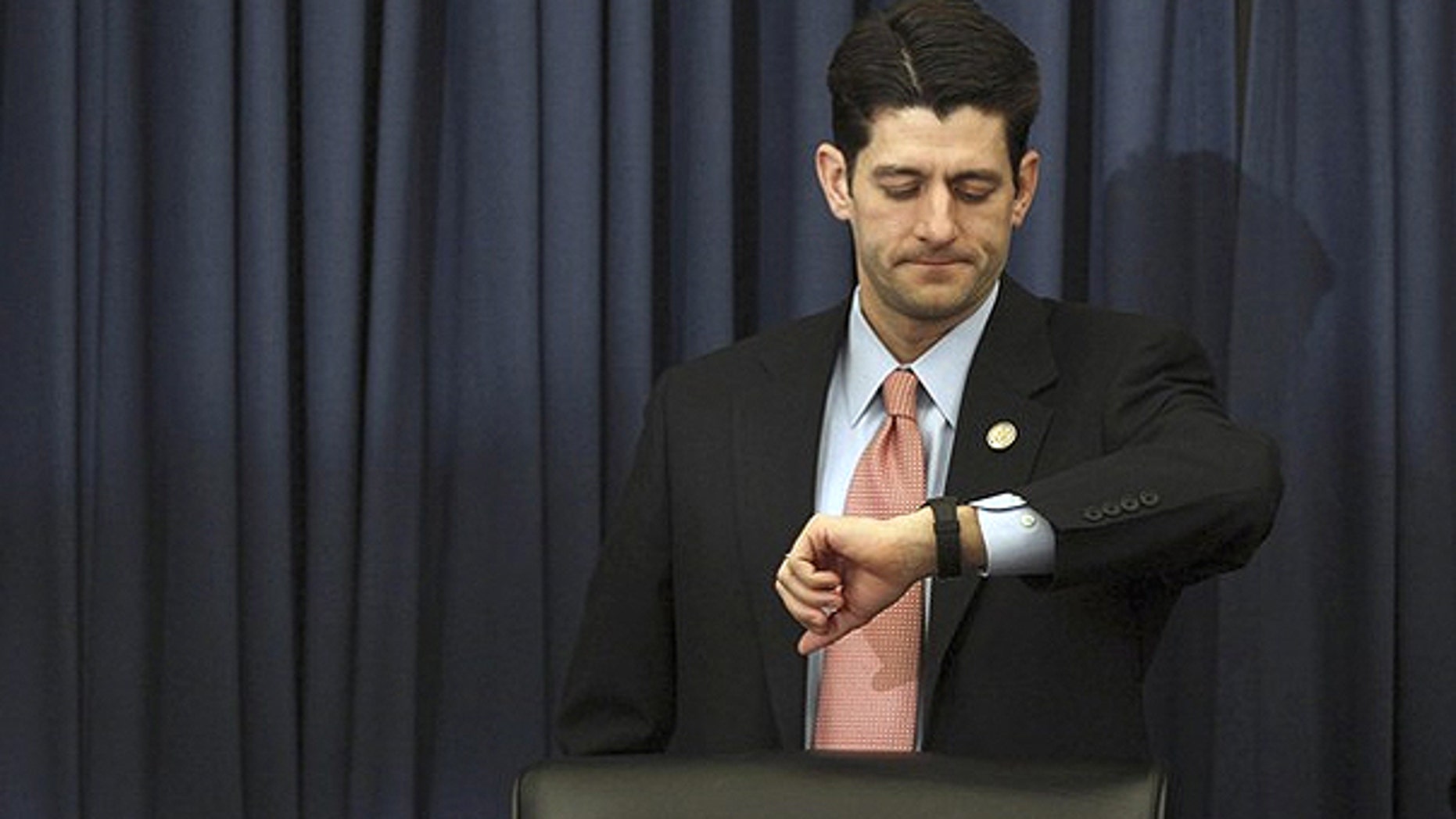 Feb. 15: U.S. House Budget Committee Chairman Paul Ryan (R-WI) checks his watch as Director of the White House's Office of Management and Budget, Jacob Lew arrives late to testify at a House Budget Committee hearing on Capitol Hill in Washington.