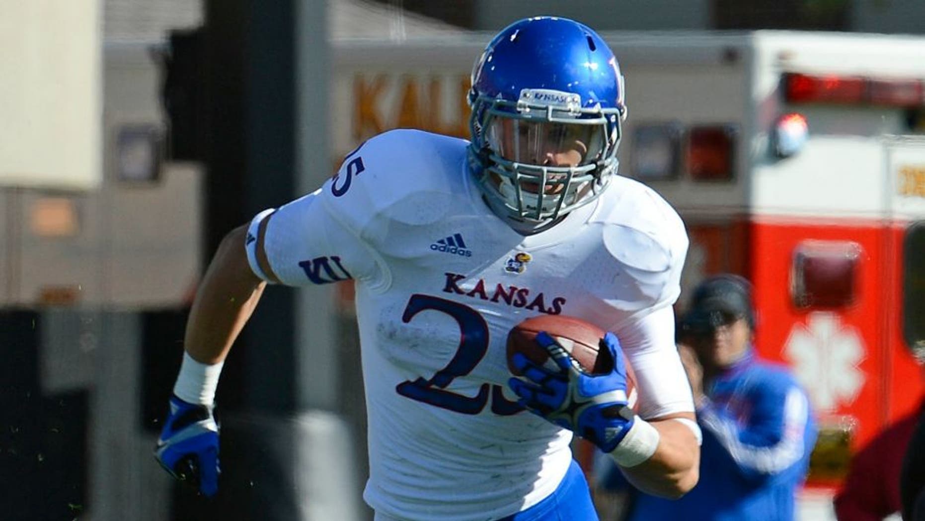 Sep 22, 2012; DeKalb, IL, USA; Kansas Jayhawks running back Brandon Bourbon (25) rushes the ball against the Northern Illinois Huskies during the second quarter at Huskie Stadium. Mandatory Credit: Mike DiNovo-US PRESSWIRE