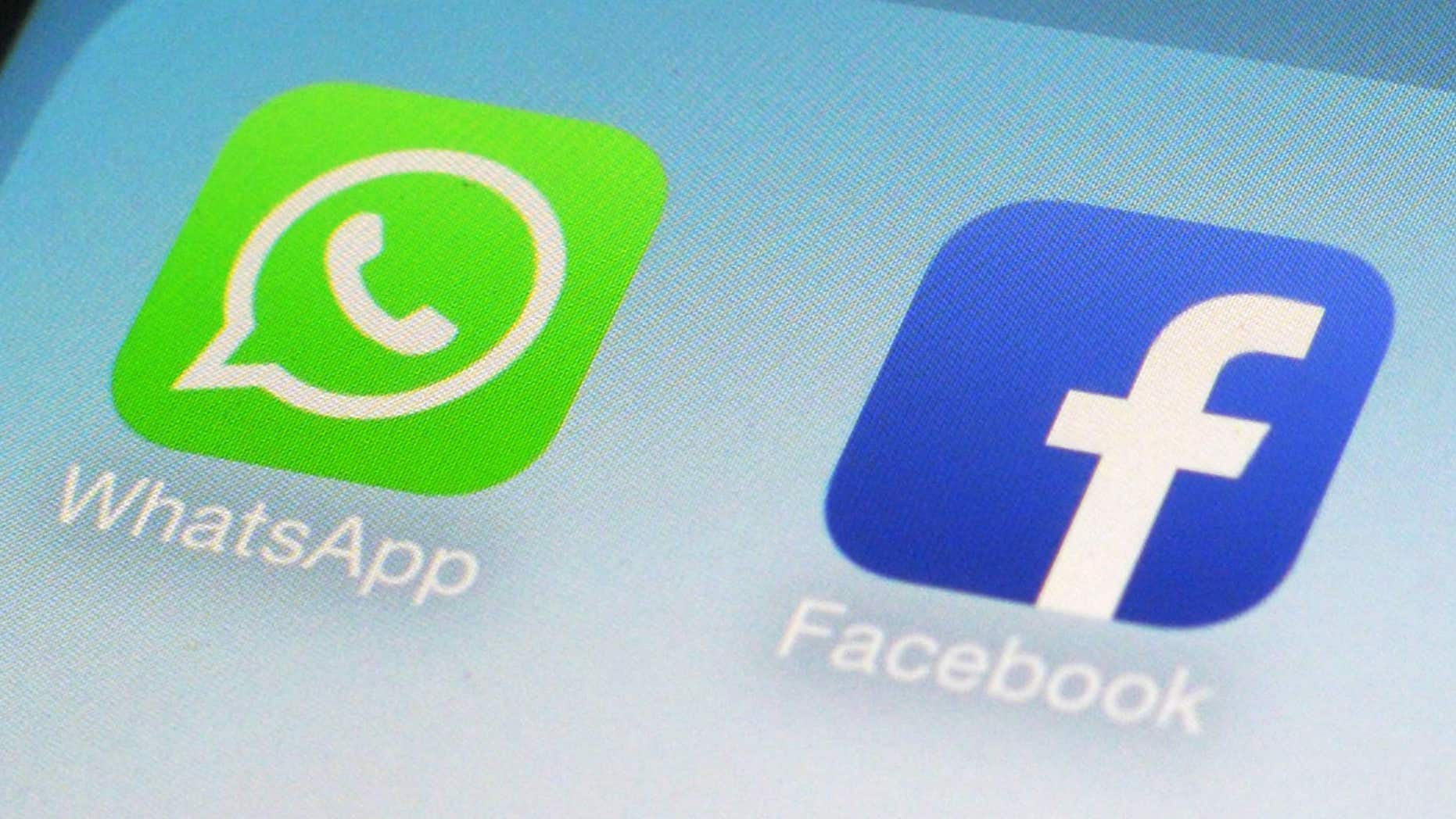 FILE - This Feb. 19, 2014, file photo, shows WhatsApp and Facebook app icons on a smartphone in New York.