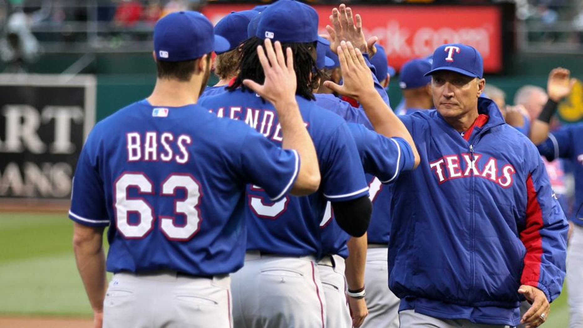 Apr 6, 2015; Oakland, CA, USA; Texas Rangers manager Jeff Banister (28) high fives his players before the game against the Oakland Athletics at O.co Coliseum. Mandatory Credit: Kelley L Cox-USA TODAY Sports