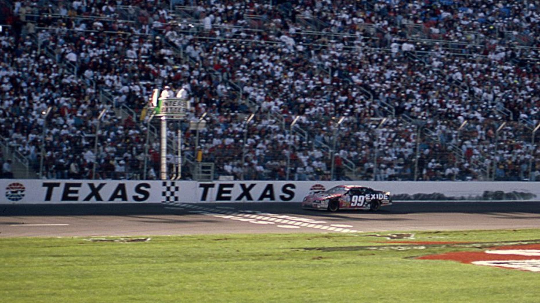 FORT WORTH, TX April 6, 1997: Jeff Burton takes the checkered flag to win the Interstate Batteries 500, the first NASCAR Cup race to be held at the new Texas Motor Speedway. (Photo by ISC Images & Archives via Getty Images)