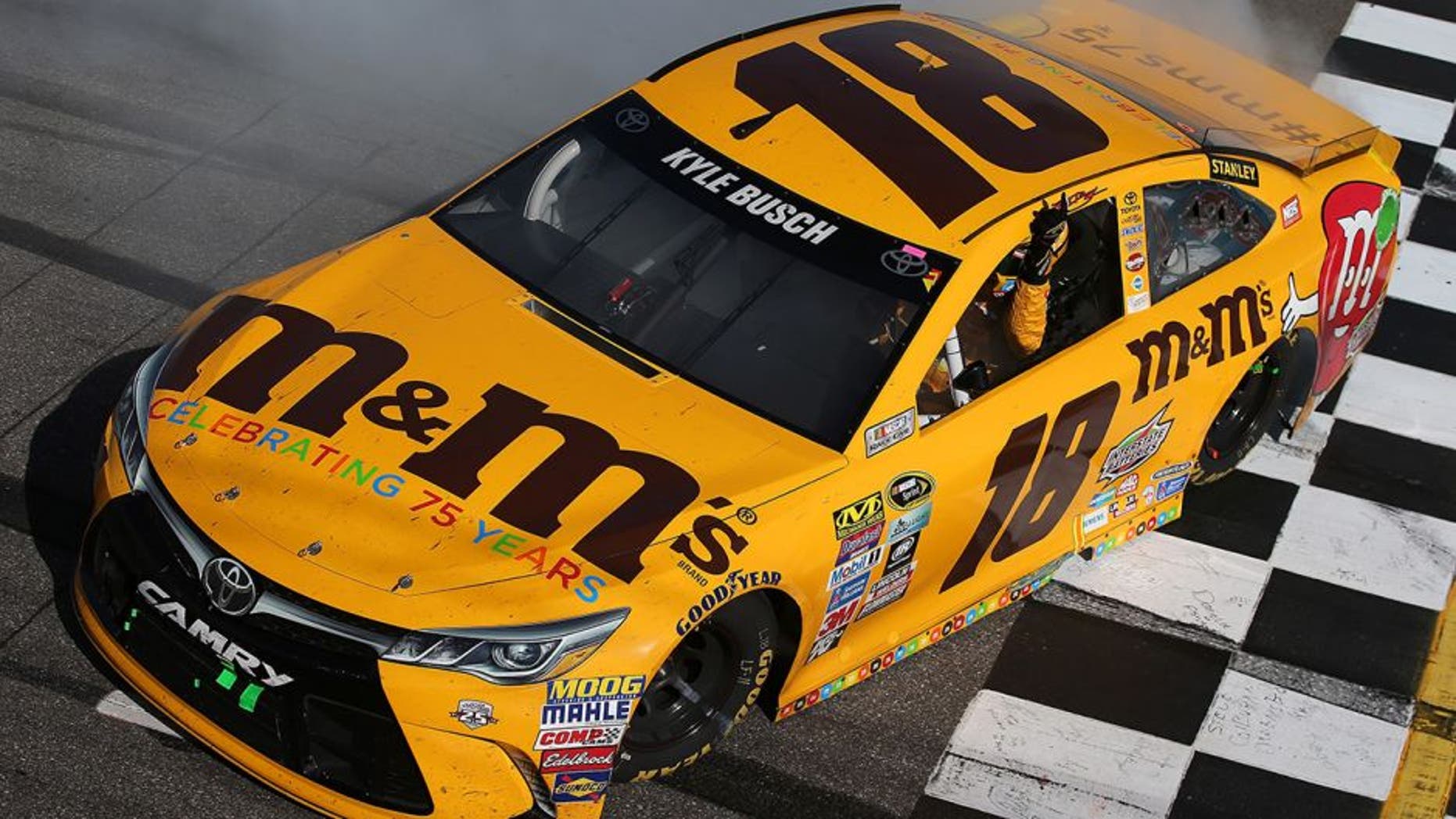 MARTINSVILLE, VA - APRIL 03: Kyle Busch, driver of the #18 M&M's 75th Anniversary Toyota, celebrates with a burnout after winning the NASCAR Sprint Cup Series STP 500 at Martinsville Speedway on April 3, 2016 in Martinsville, Virginia. (Photo by Sean Gardner/NASCAR via Getty Images)