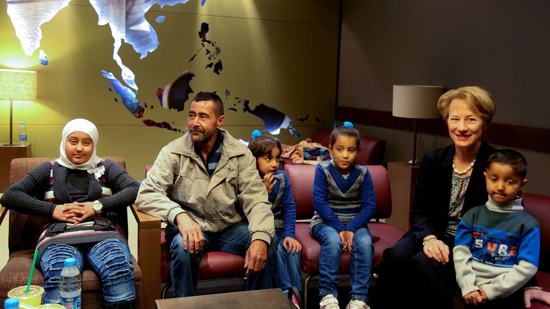 April 6, 2016: U.S. Ambassador to Jordan Alice Wells, right, meets with Syrian refugee Ahmad al-Abboud, center, and his family at the International Airport of Amman, Jordan.