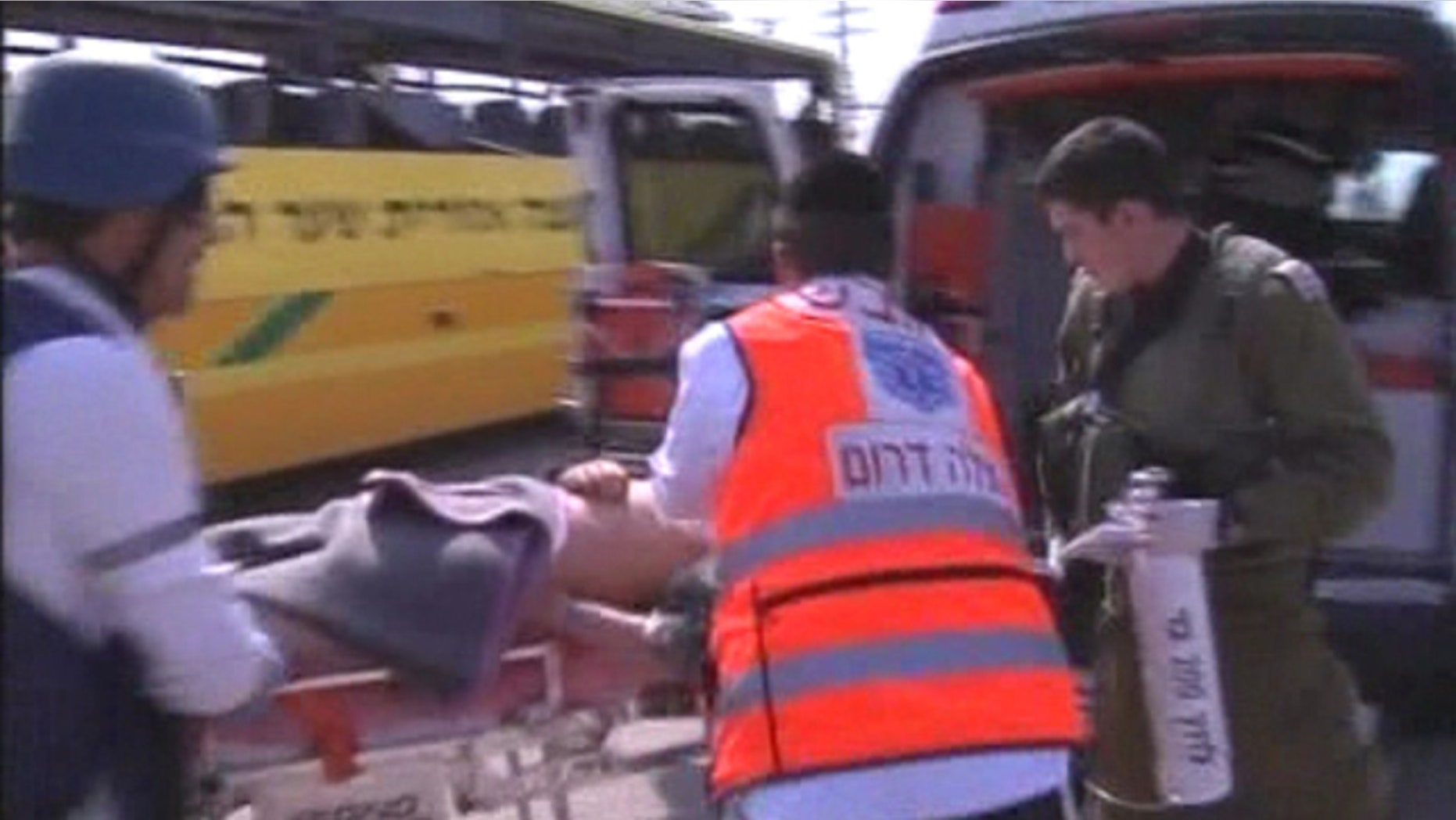 April 7: An injured person is loaded into an ambulance after a Palestinian mortar strikes an Israeli bus.