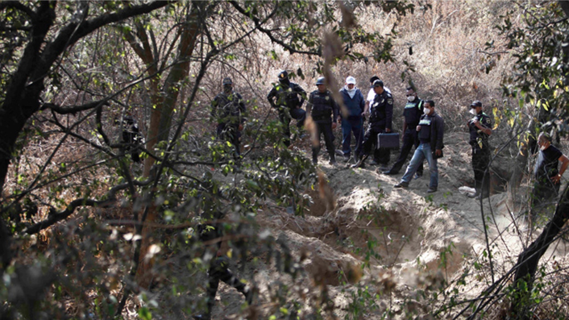 Feb. 27: State police guard the site where at least five bodies were found in a clandestine grave in Santa Mara Tlalmanalco on the outskirts of Mexico City.