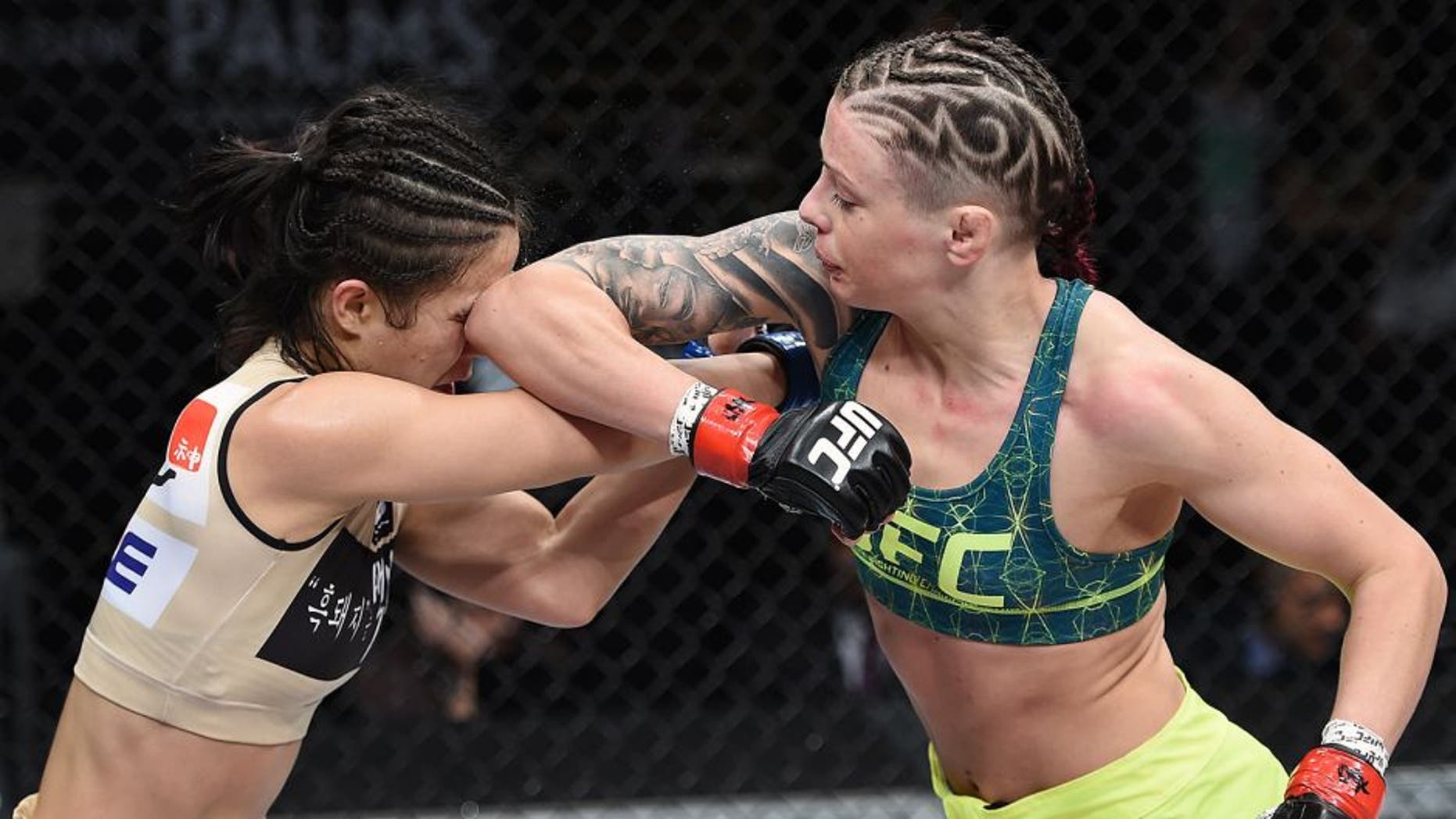 LAS VEGAS, NEVADA - DECEMBER 12: (R-L) Joanne Calderwood elbows Seohee Ham in their strawweight fight during The Ultimate Fighter Finale event inside the Palms Casino Resort on December 12, 2014 in Las Vegas, Nevada. (Photo by Jeff Bottari/Zuffa LLC/Zuffa LLC via Getty Images)