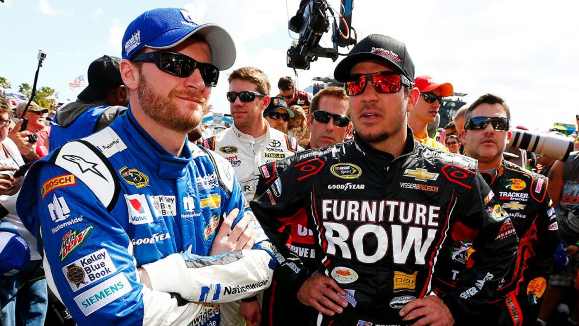 DAYTONA BEACH, FL - FEBRUARY 22: Dale Earnhardt Jr., driver of the #88 Nationwide Chevrolet, left, and Martin Truex Jr., driver of the #78 Furniture Row/Visser Percision Chevrolet, take part in pre-race ceremonies for the NASCAR Sprint Cup Series 57th Annual Daytona 500 at Daytona International Speedway on February 22, 2015 in Daytona Beach, Florida. (Photo by Jonathan Ferrey/NASCAR via Getty Images)