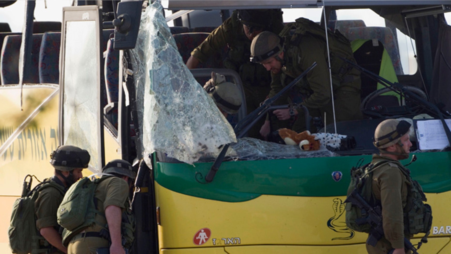 April 8: Israeli soldiers inspect a school bus hit by an anti-tank missile fired from the Gaza Strip near the border between southern Israel and Gaza at Sa'ad, Israel.