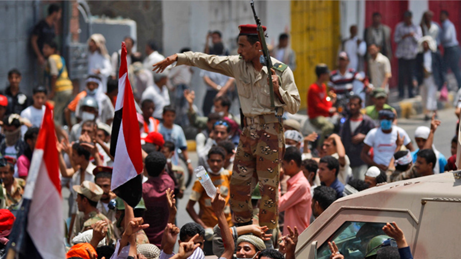April 7: A Yemeni army officer gestures to anti-government protesters attending a demonstration demanding the resignation of Yemeni President Ali Abdullah Saleh in Taiz, Yemen.