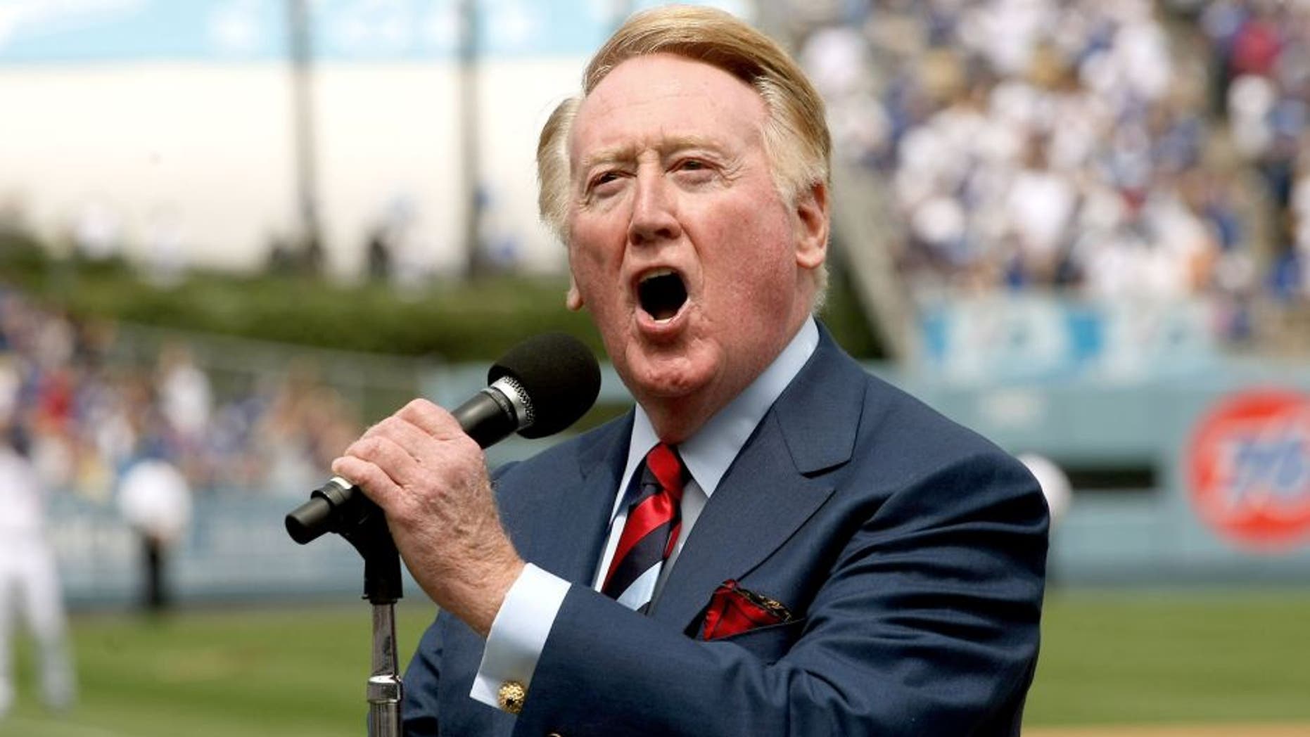 LOS ANGELES - APRIL 13: Dodgers broadcaster Vin Skully gives the call of "It's time for Dodger baseball!" during pregame ceremonies for the Los Angeles Dodgers home opener against the San Francisco Giants on April 13, 2009 at Dodger Stadiium in Los Angeles, California. (Photo by Stephen Dunn/Getty Images) *** Local Caption *** Vin Skully