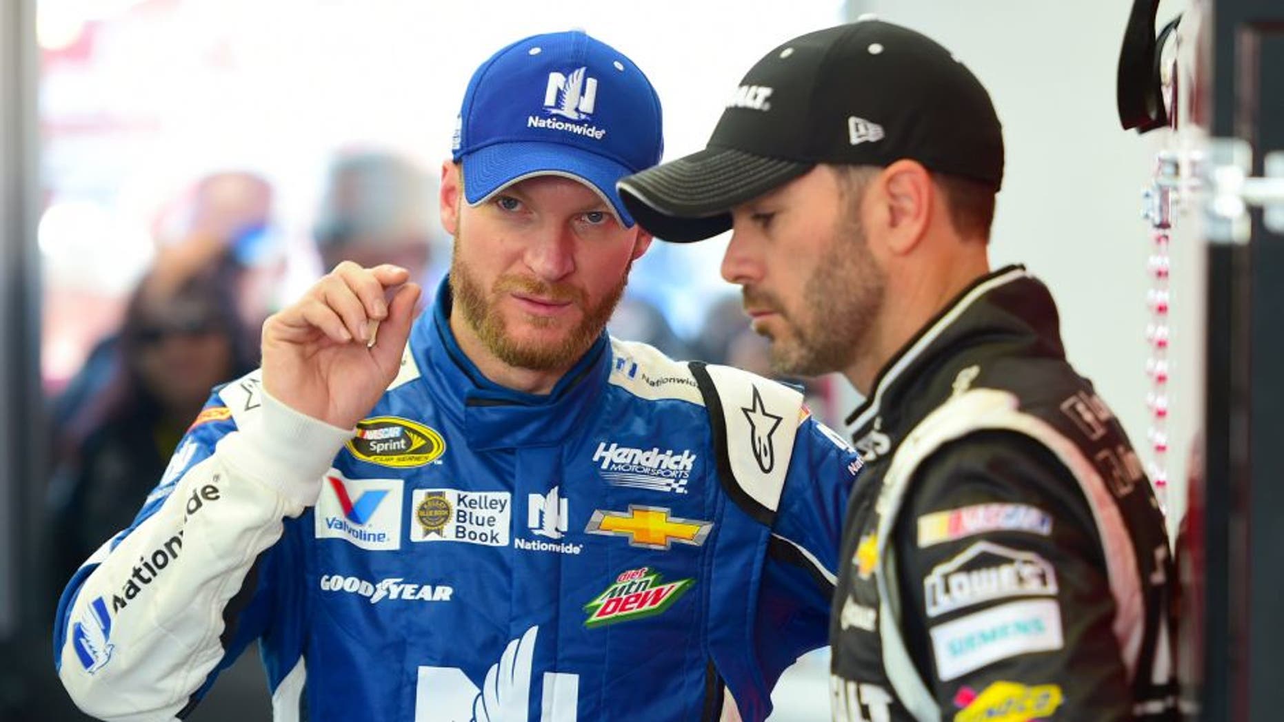 Dale Earnhardt Jr., driver of the #88 Nationwide Chevrolet, speaks with Jimmie Johnson, driver of the #48 Kobalt Tools Chevrolet, in the garage during qualifying for the NASCAR XFINITY Series Boyd Gaming 300 at Las Vegas Motor Speedway on March 7, 2015 in Las Vegas, Nevada. (Photo by Robert Laberge/Getty Images)