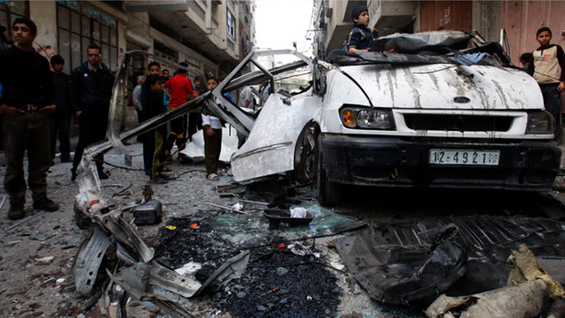 April 9: Palestinian children gather next to a car destroyed in an Israeli strike on Gaza City.