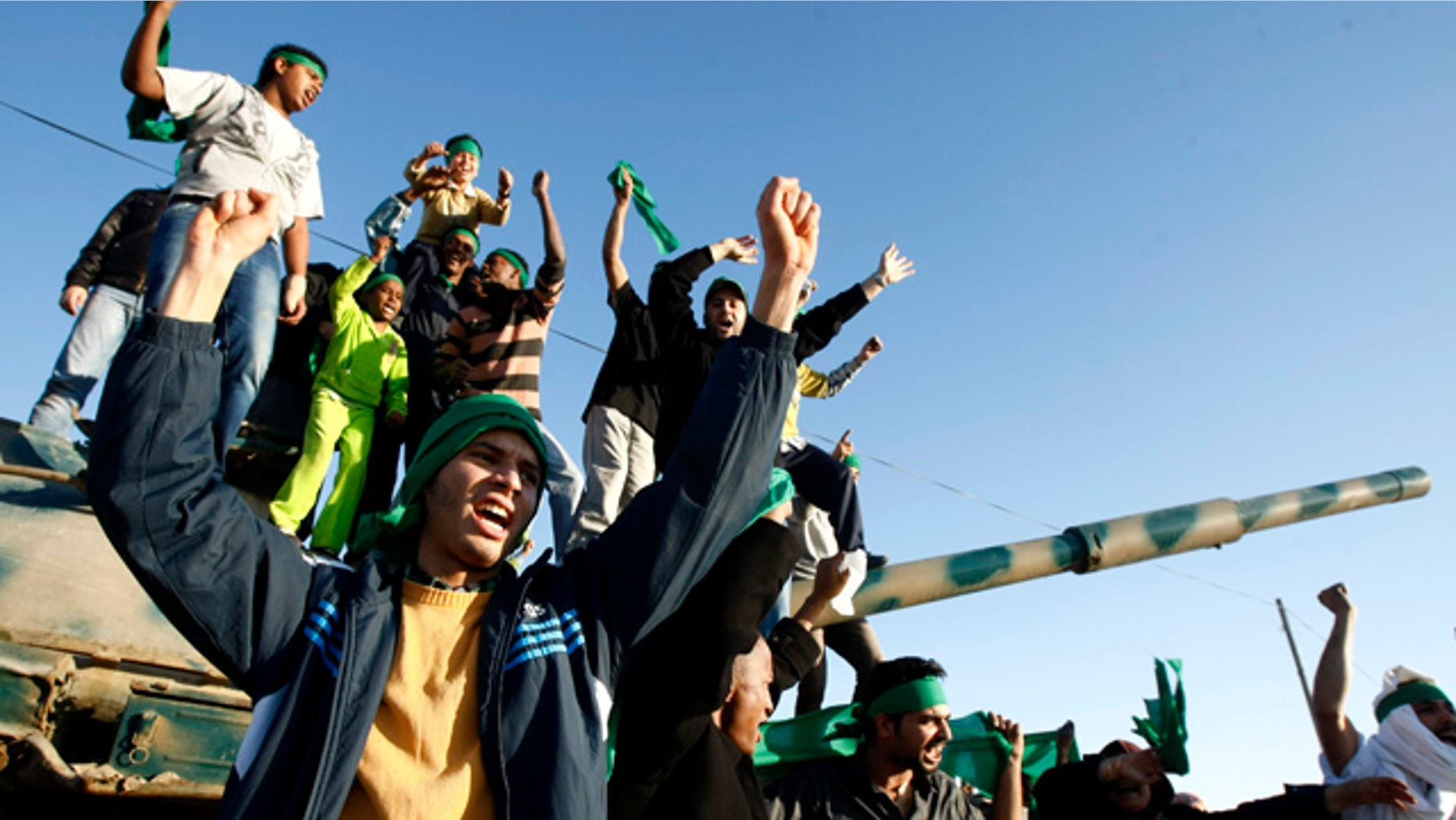 April 8: In this photo taken during a trip organized by Libyan authorities, Libyan youth wave their national flags and chant pro-Libyan leader slogans in the outskirts of the coastal city of Misrata.