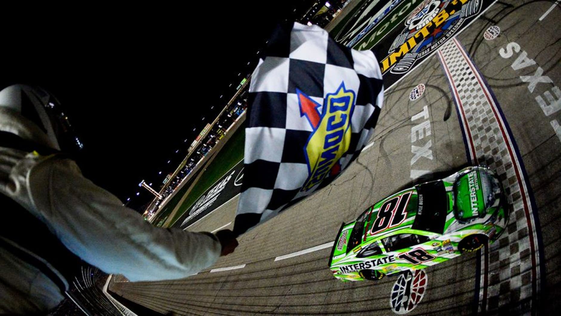 FORT WORTH, TEXAS - APRIL 09: Kyle Busch, driver of the #18 Interstate Batteries Toyota, takes the checkered flag to win the NASCAR Sprint Cup Series Duck Commander 500 at Texas Motor Speedway on April 9, 2016 in Fort Worth, Texas. (Photo by Robert Laberge/NASCAR via Getty Images)