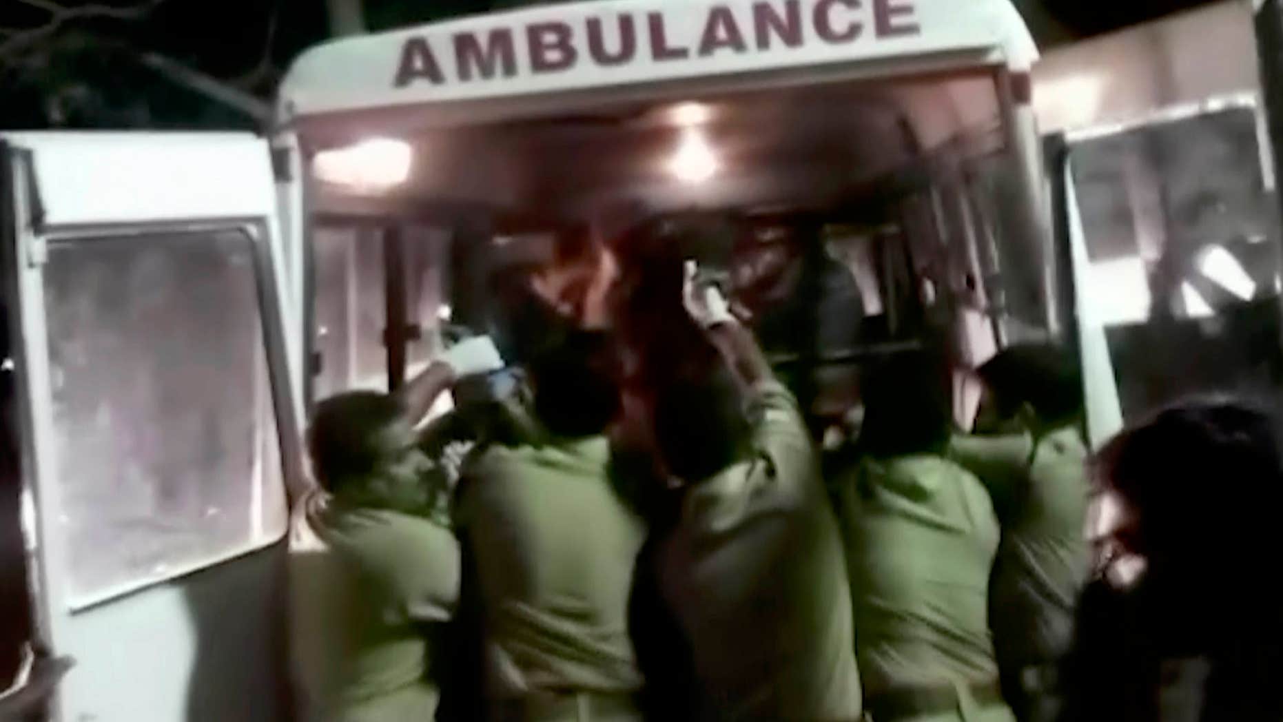 April 10, 2016: In this image made from video, officials put an injured person into an ambulance following a fire at a temple in Kollam, in the southern Indian state of Kerala.