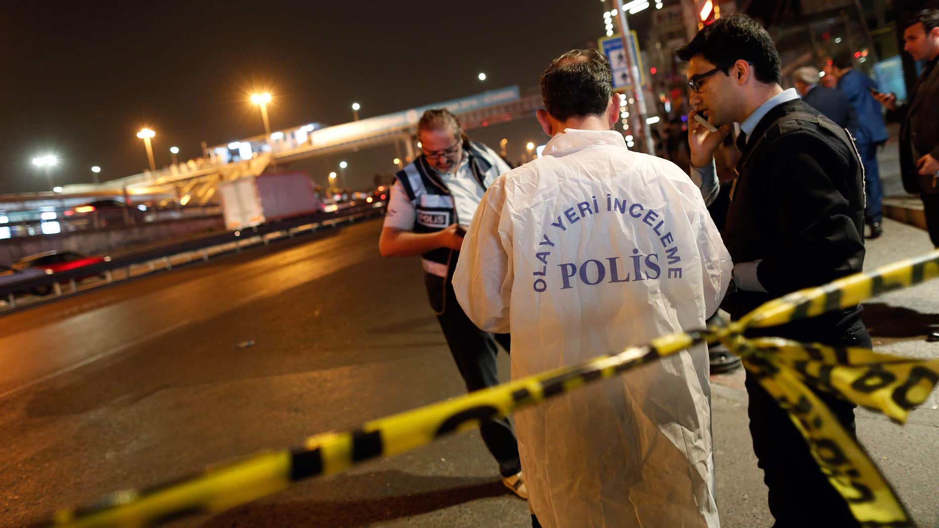 April 9, 2016: Police forensic officers investigate an explosion near an overpass in Istanbul.