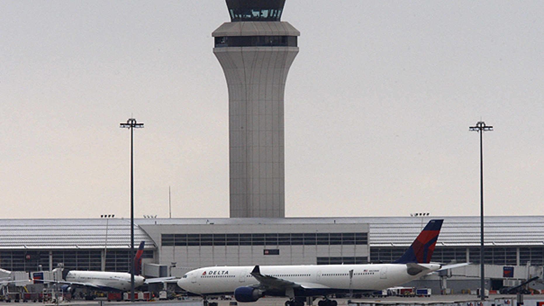 In this Dec. 26, 2009, file photo, Delta-Northwest Airlines plane N820NW is pulled back to the terminal at the Detroit Metropolitan airport in Romulus, Mich.